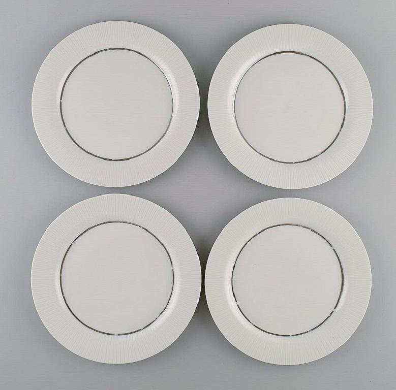 Tapio Wirkkala for Rosenthal. Eight rare Modulation lunch plates in porcelain with fluted rim. 
Platinum Detail. Classic and timeless design. 1960s.
Measure: Diameter: 21.5 cm.
In excellent condition. Four plates with light wear.
Stamped.