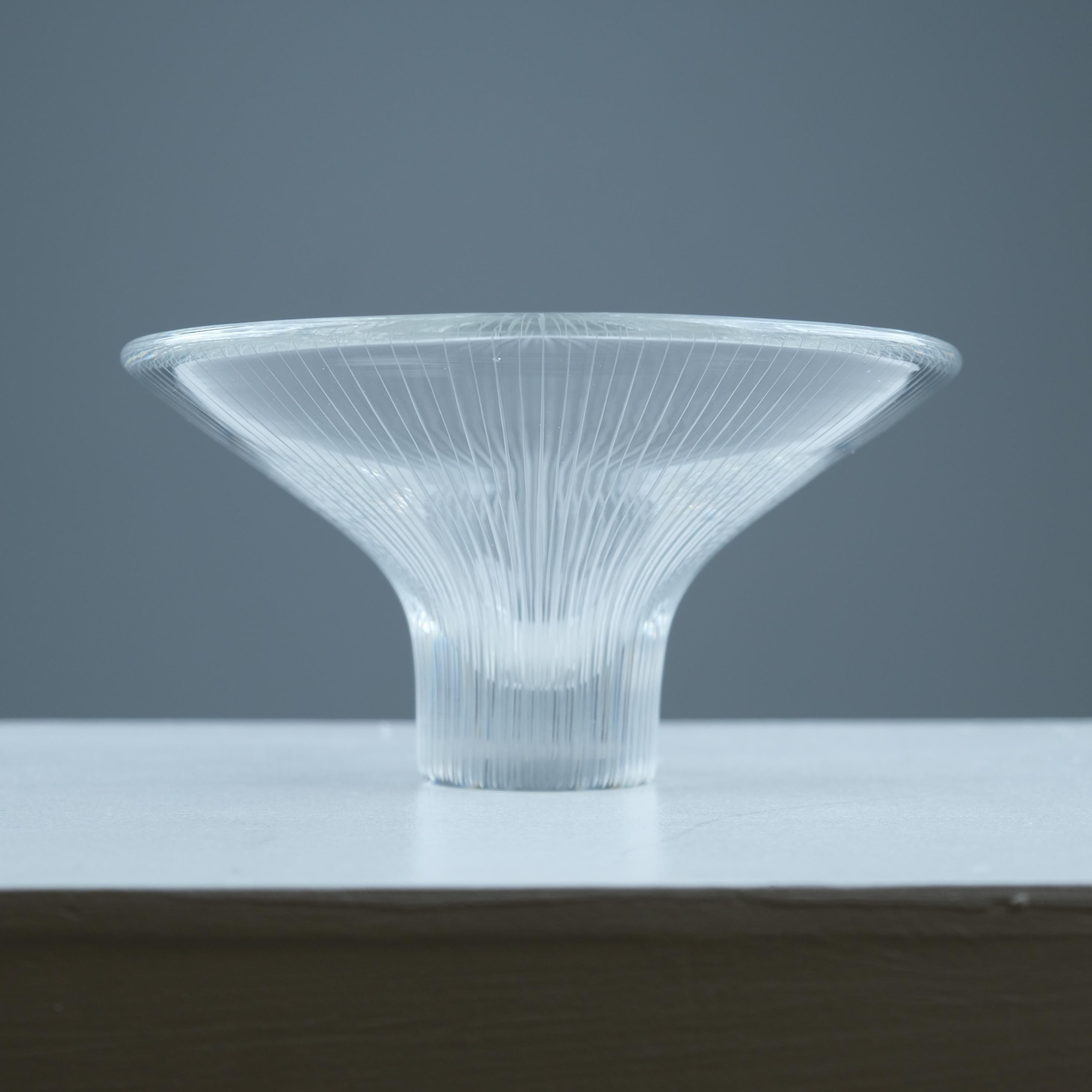 A beautiful Line-engraved art glass vase model 3138, designed by Tapio Wirkkala and manufactured by Iittala in Finland in the 1950s. Minimalist glass sculpture mimicking a blossoming flower. In the manufacturing process the crystal glass is blown