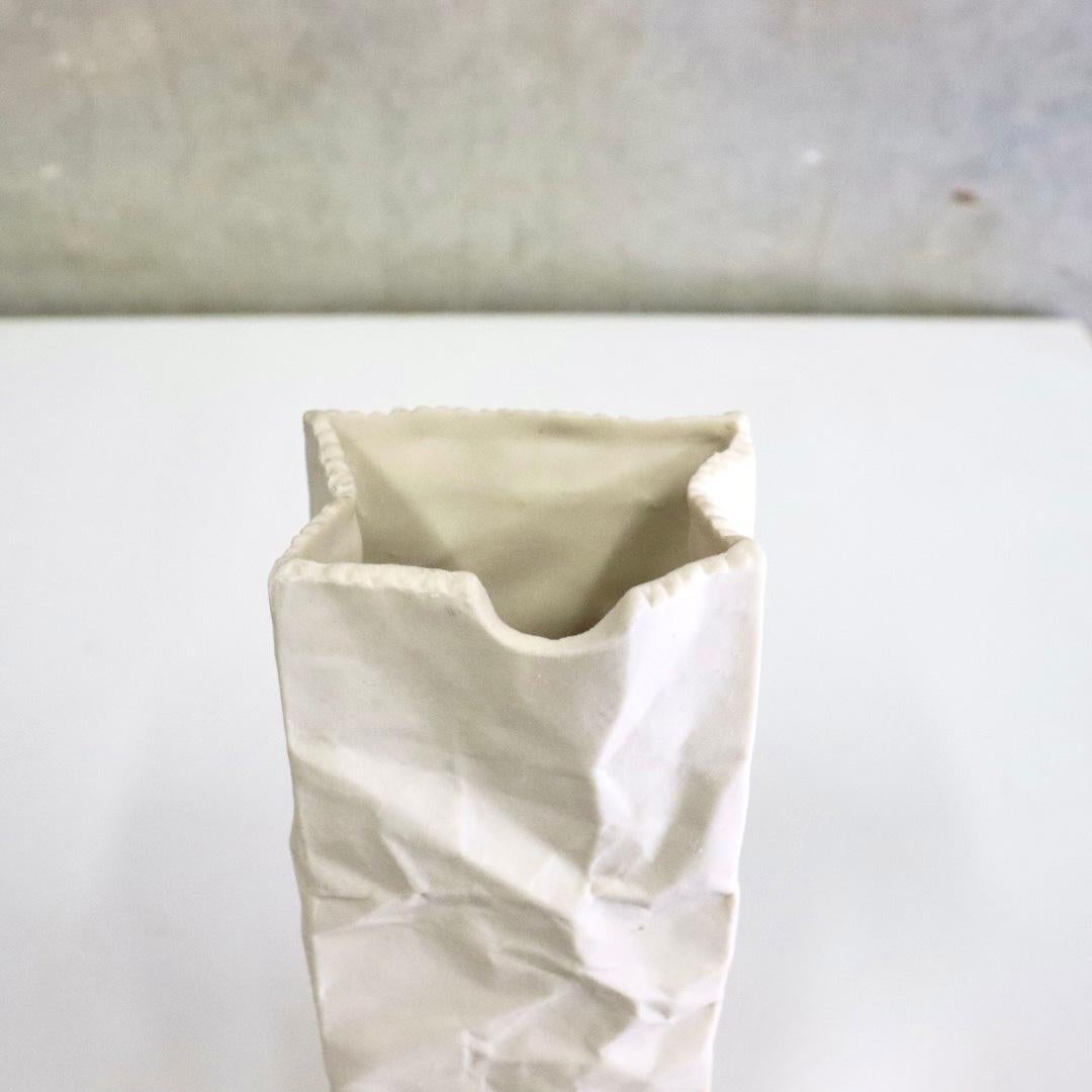 This is a sculptural ceramic bag made by Tapio Wirkkala vase in the 1970’s. Serrated top and crinkles make the bag look like a real paper sack. Beautiful and fun ceramic vase that is sure to be a conversation starter. Put a single stem or a couple