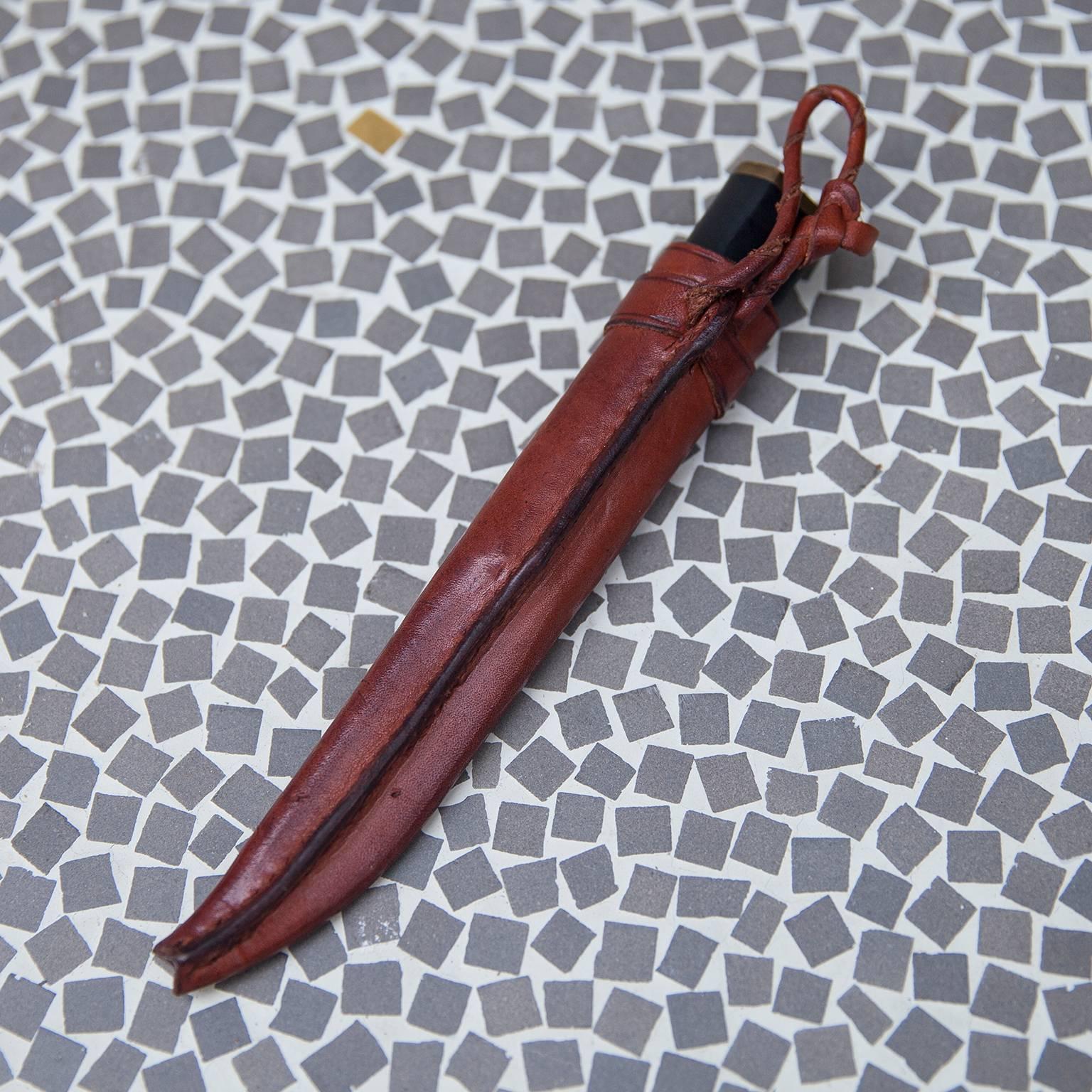 Stainless steel blade with black nylon handle and brass fittings. Leather sheathes included. Original natural hide Sheathes with bear claw impressions. Blades marked with manufacturer's information and the artist's name.