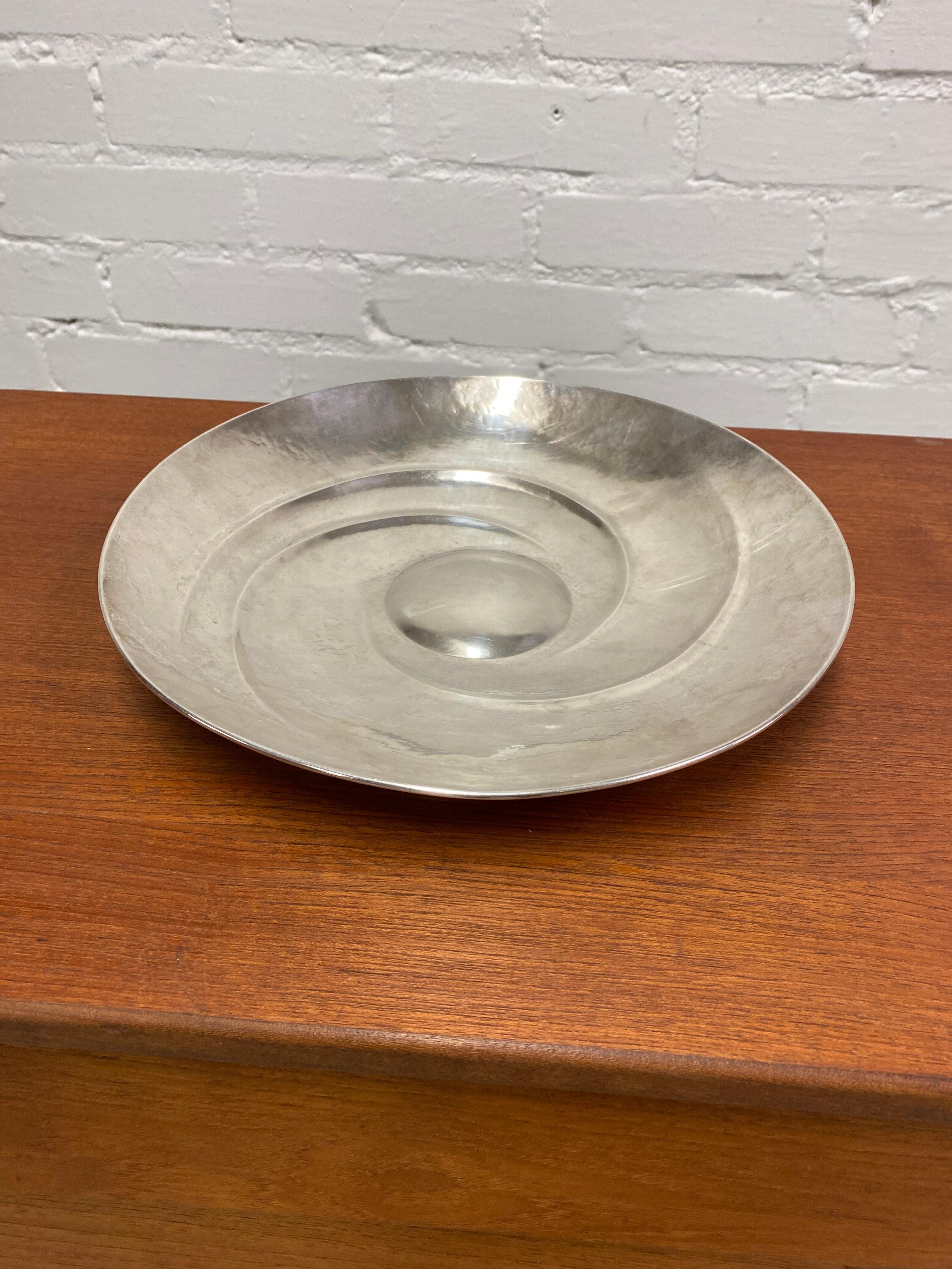 A beautiful decorative dish in silver, designed by Tapio Wirkkala and manufactured by Kultakeskus Oy in the 1970s Finland. This piece is documented in Tapio Wirkkala's book and the model number is 143. A very simple but elegant centerpiece that fits