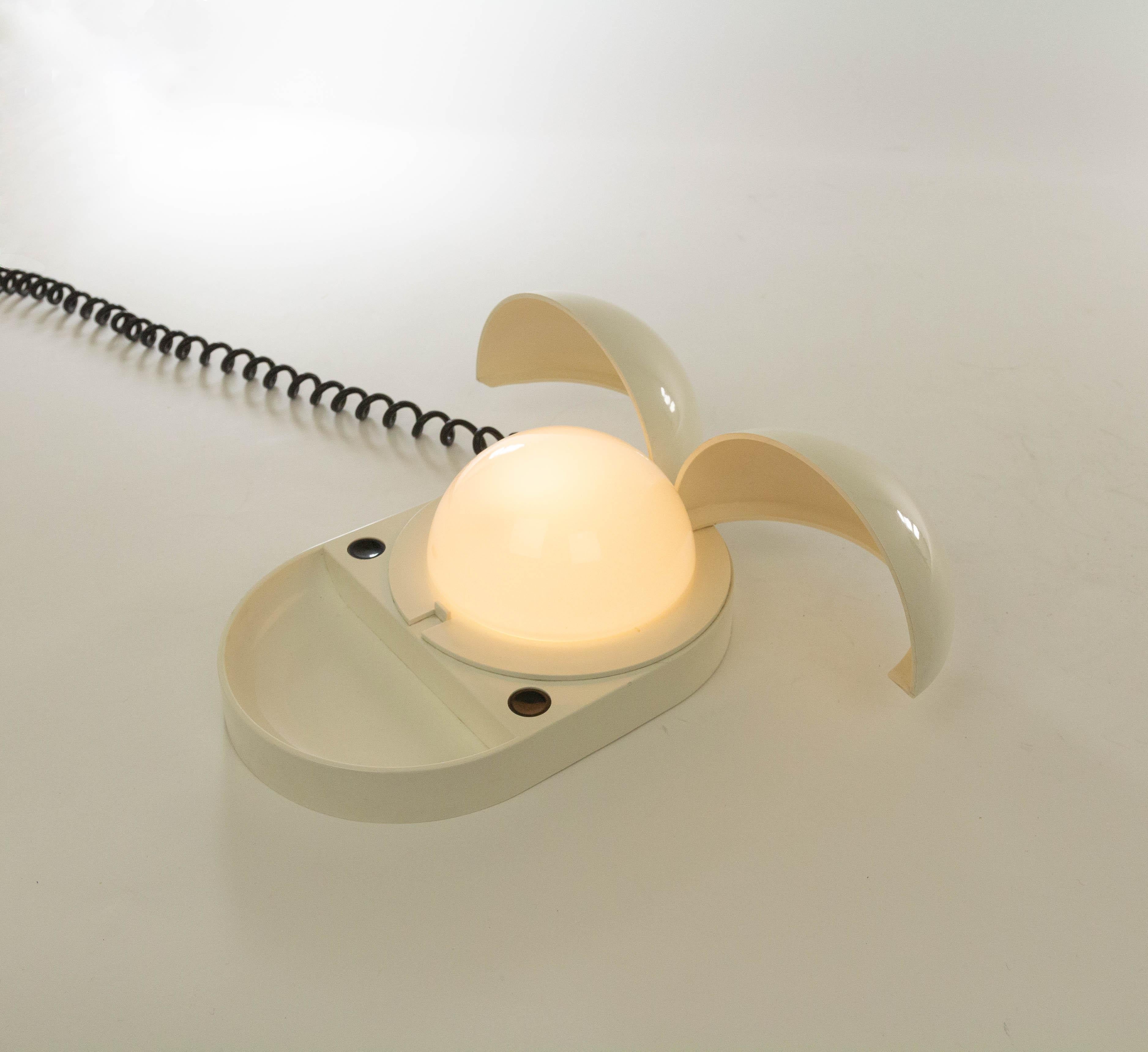 Tapira desk lamp designed by Gianemilio, Piero and Anna Monti (G.P.A. Monti) and produced by Fontana Arte, during the 1970s.

The lamp is made of plastic and contains an opaline glass hemisphere. Above this glass hemisphere are two wings that can