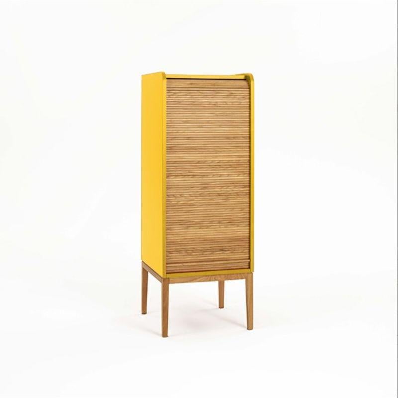 Tapparelle medium cabinet, mustard yellow by Colé Italia with Emmanuel Gallina
Dimensions: H.115 D.42 W.42 cm.
Materials: Container with legs and “tapparella” sliding shutter in solid oak.
Matt lacquered structure; inside 2 oak veneered