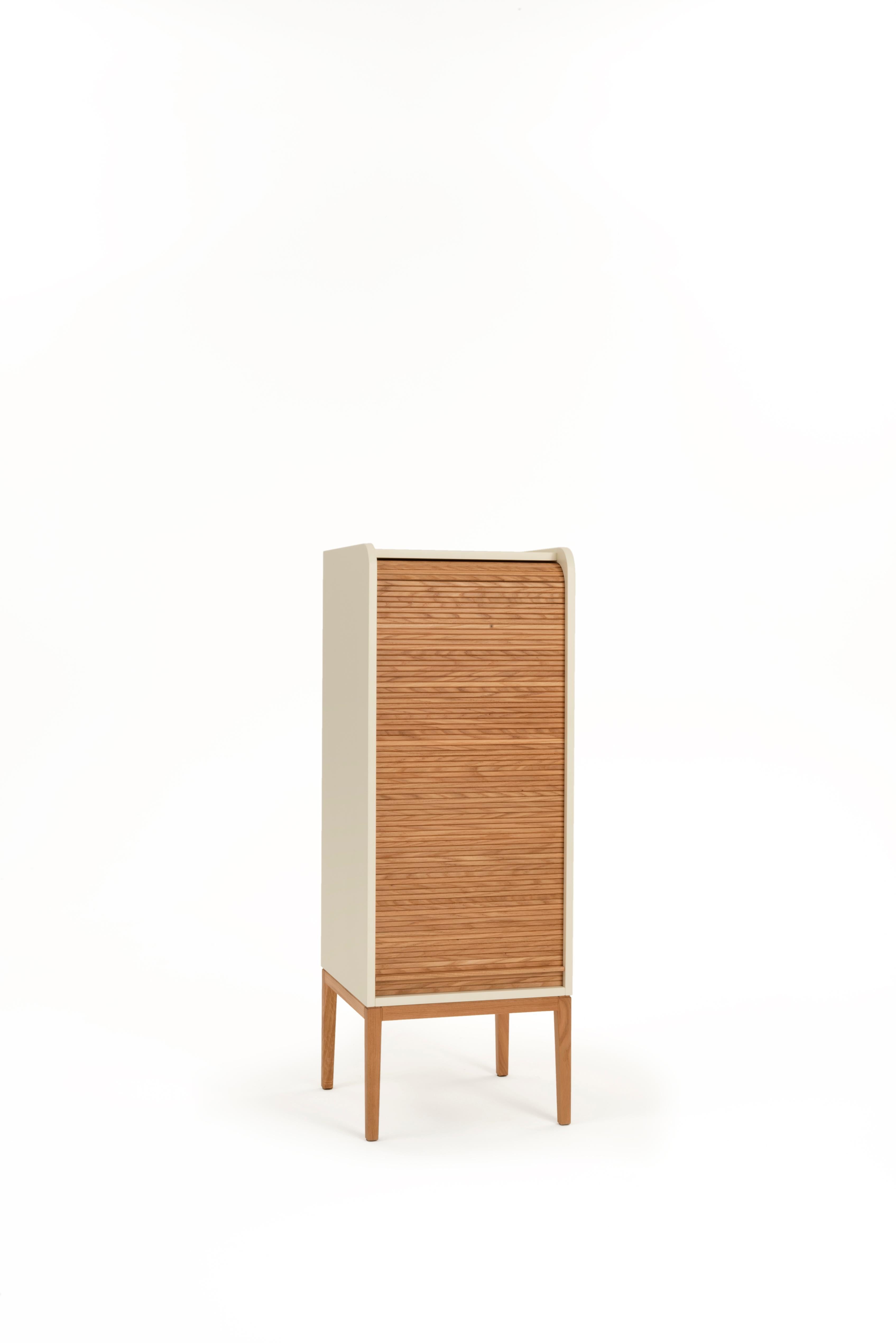 Tapparelle Medium Cabinet, Sand White by Colé Italia with Emmanuel Gallina
Dimensions: H.115 D.42 W.42 cm
Materials: Container with legs and “tapparella” sliding shutter in solid oak.
Matt lacquered structure; inside 2 oak veneered shelf

Also