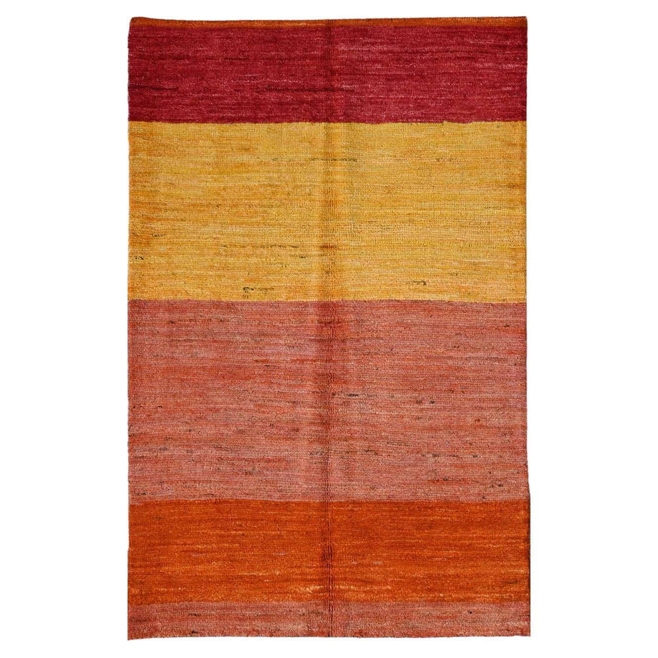 Taimany Afghan rug with color variation from red to orange For Sale