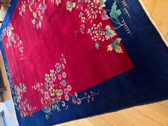 Art Deco' rug deep red background, blue border and colorful flower cascade
