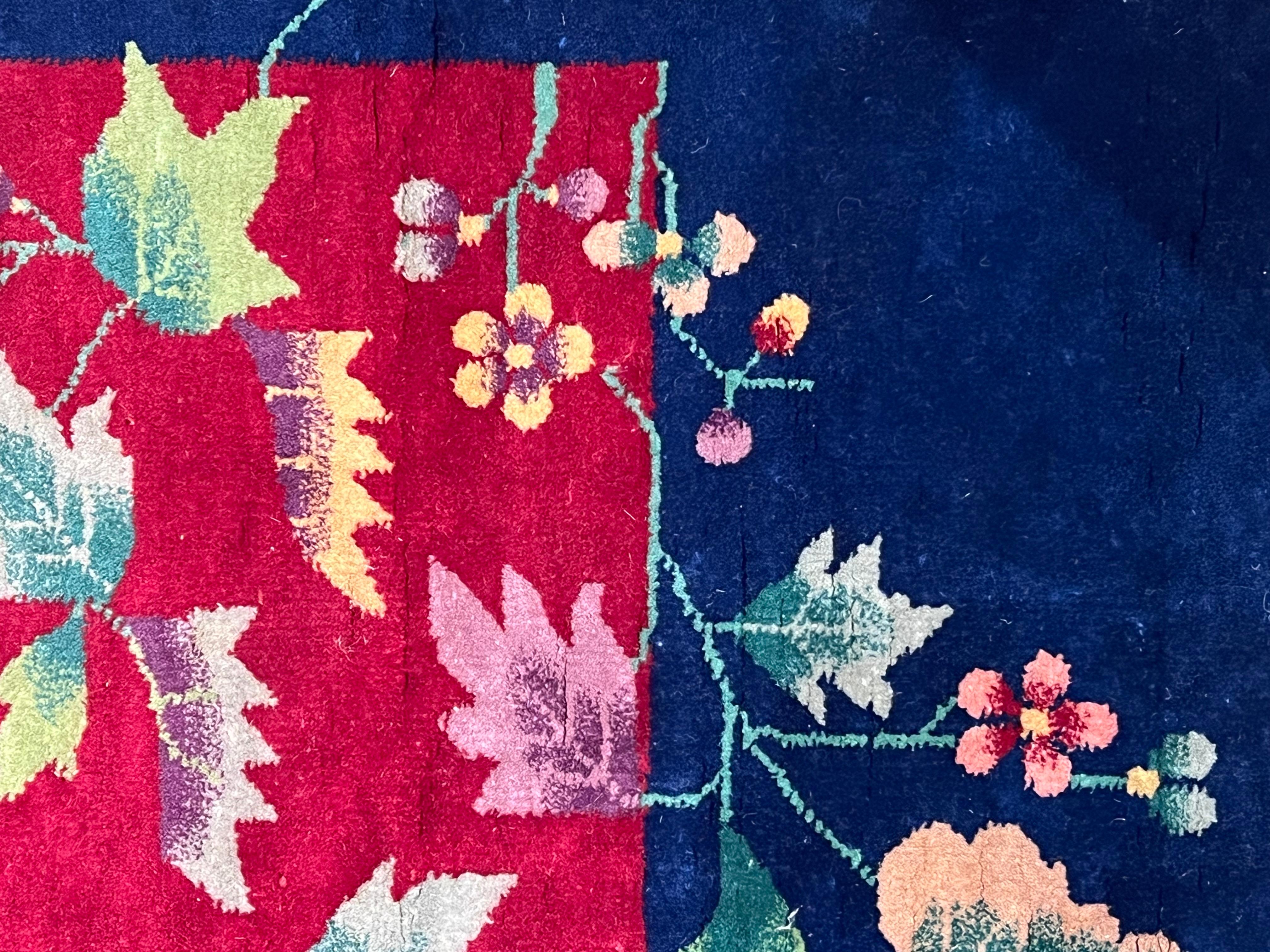Hand-Knotted Art Deco' rug deep red background, blue border and colorful flower cascade For Sale