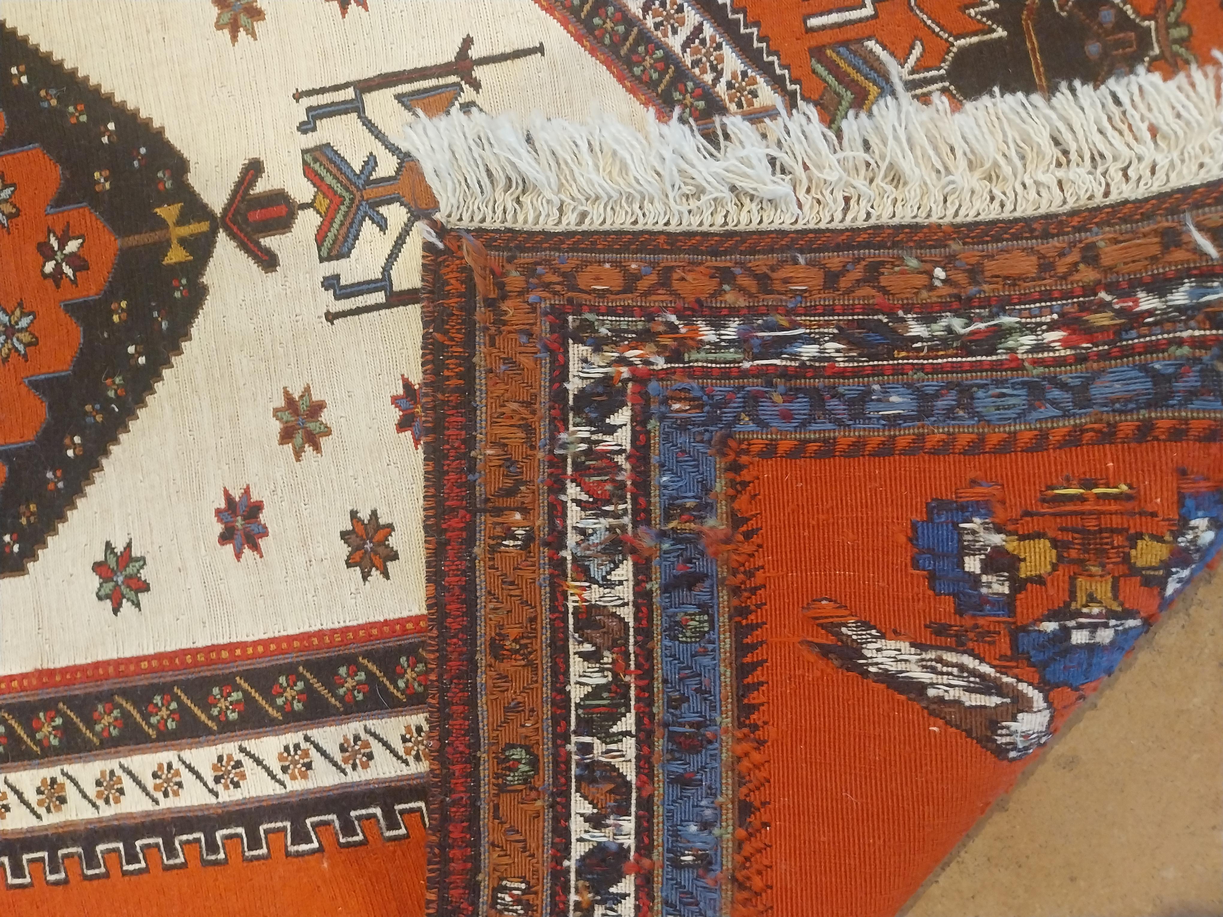 Handwoven in wool and sourced from Turkey around 1960, this item is a wonderful example of a vintage Kilim rug with a mid-century central diamond pattern, known for producing Kilim rugs with a modern, maximalist appeal in geometry and bright hues.