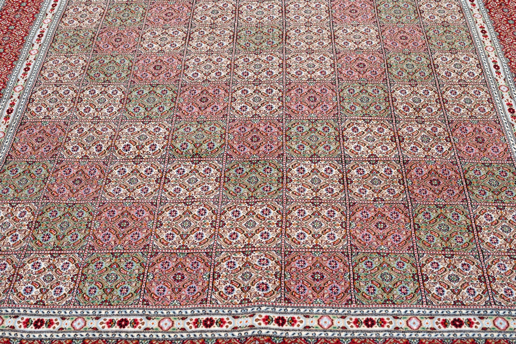 Stimmungsvoller Teppich aus persischer Wolle und Seide. Vollständig handgeknüpft.
Stimmungsvolle Teppiche aus der gleichnamigen Stadt  im Süden des Irans, sind meisterhafte Beispiele für die hohe handwerkliche Tradition persischer Teppiche.
Dieses