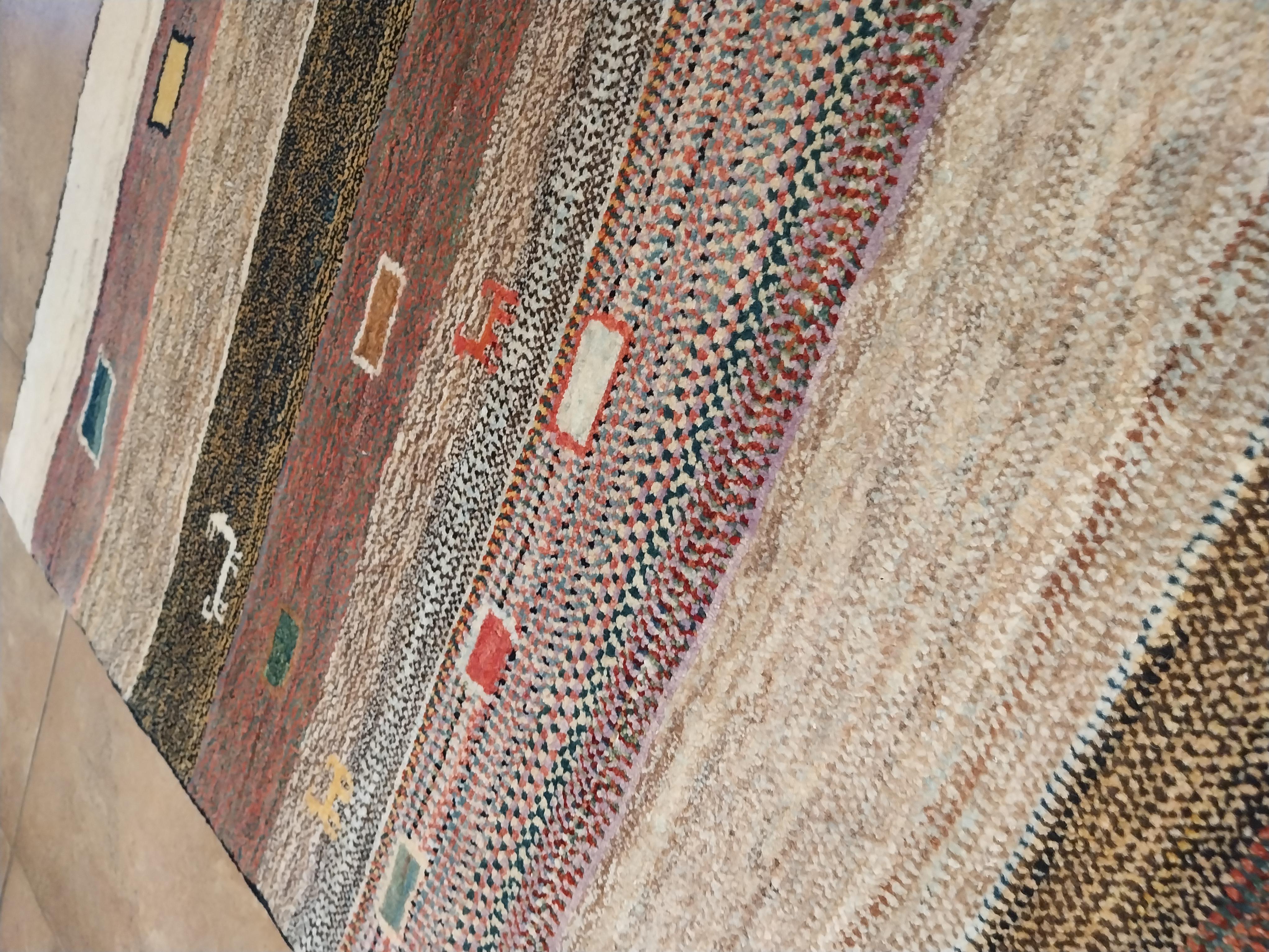 Hand-knotted Vintage Persian rug, Gabbeh.
Gabbeh are carpets from southern Persia. They are part of the ancient Persian tradition.
They are refurbished carpets for their construction quality and sturdiness. This rug features geometric patterns and