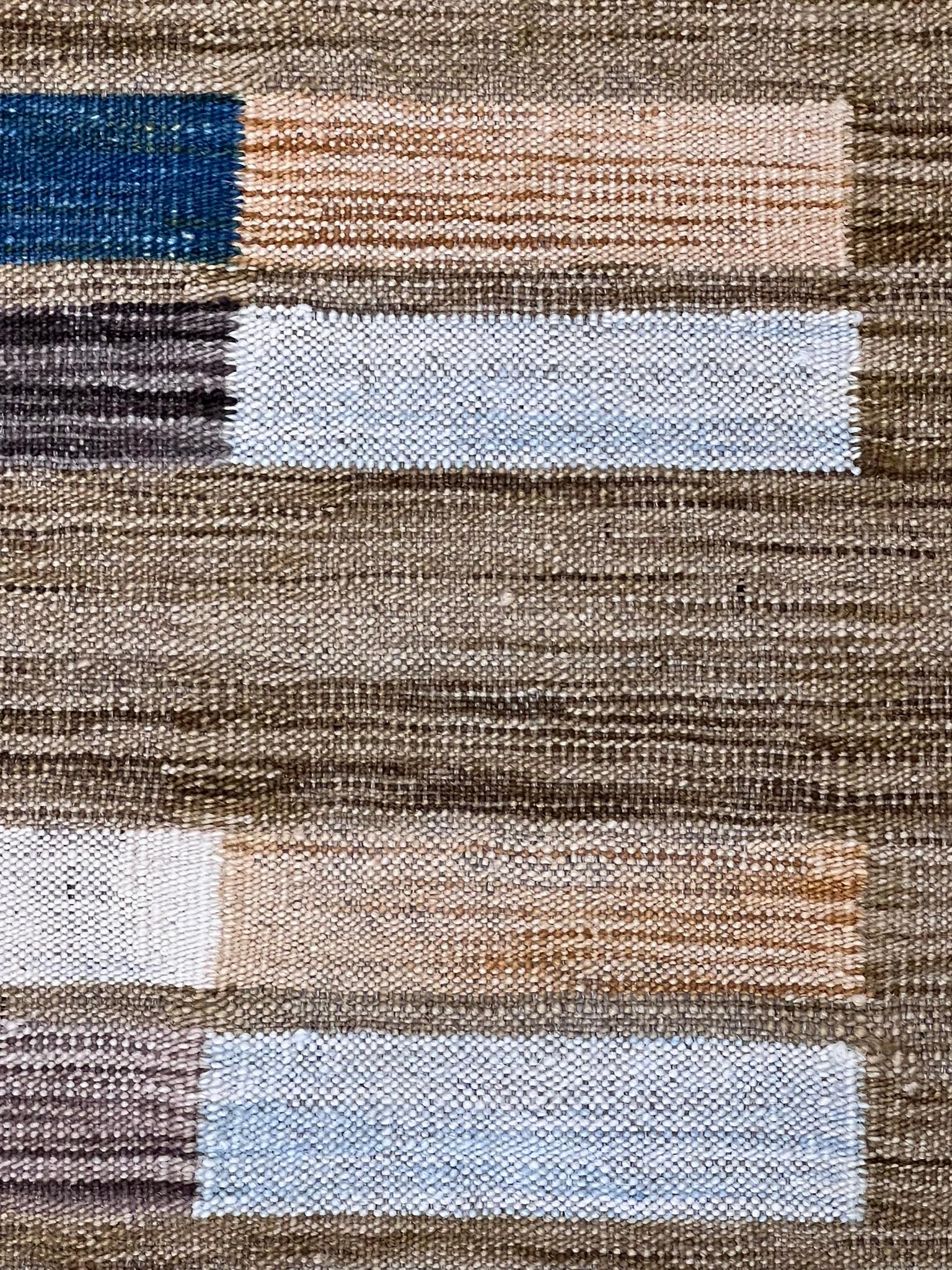 The design with a distinctly modern layout and the absolutely different colors from the traditional ones are the main features of this Afghan-made kilim. The flat-weave technique enhances these characteristics, making this artifact a suitable piece