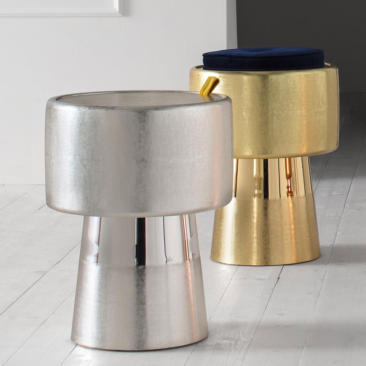Functioning as a side table, a box or a champagne bucket, this sculptural piece is a unique work of art that features an opening mechanism with a yellow velvet flap that helps to remove the top. Made entirely of silver, it boasts a brushed finish