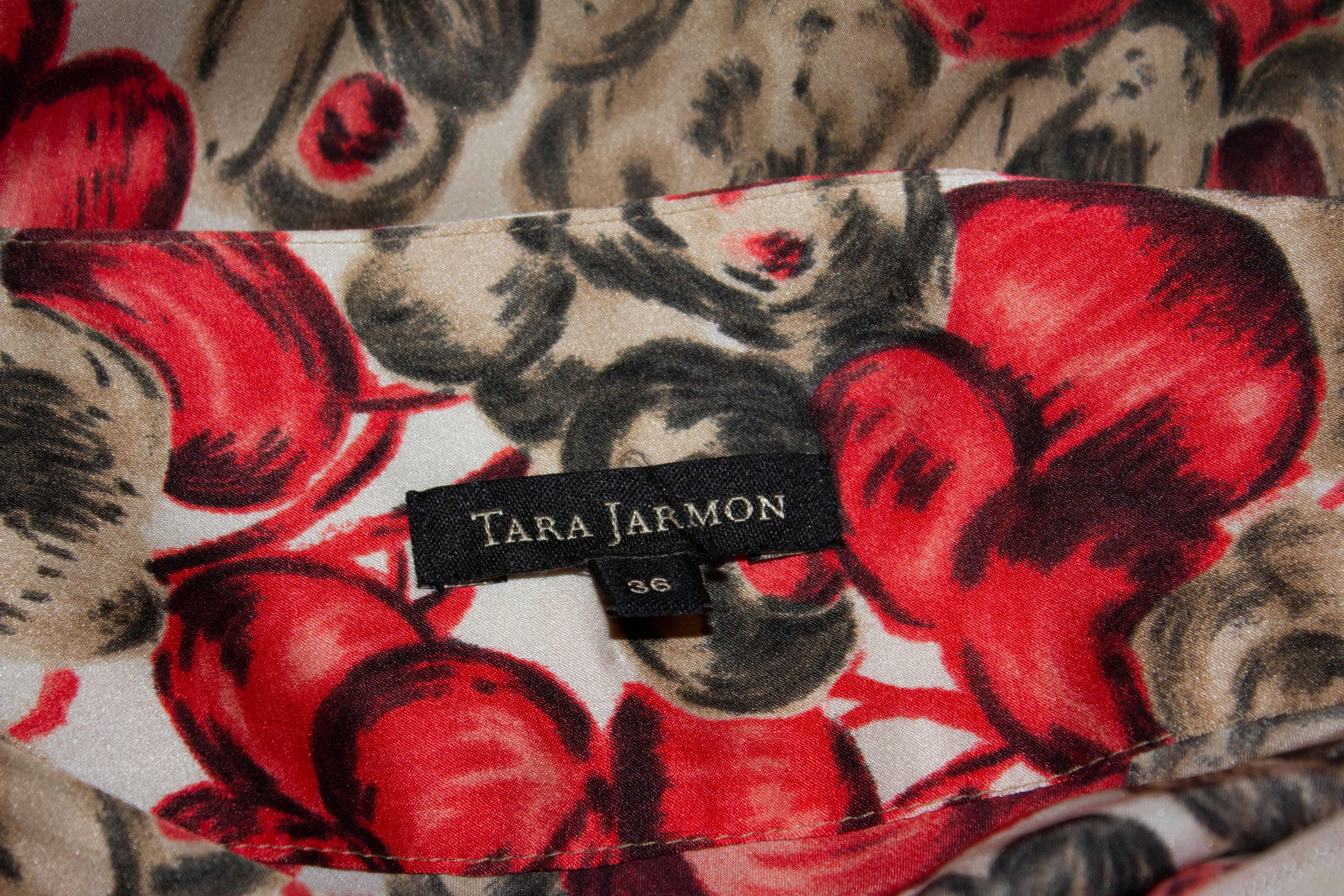 A fun and flirty silk skirt by Tara Jamon in a red and white cherry print. The skirt has a side zip opening , detail on the front and is unlined.