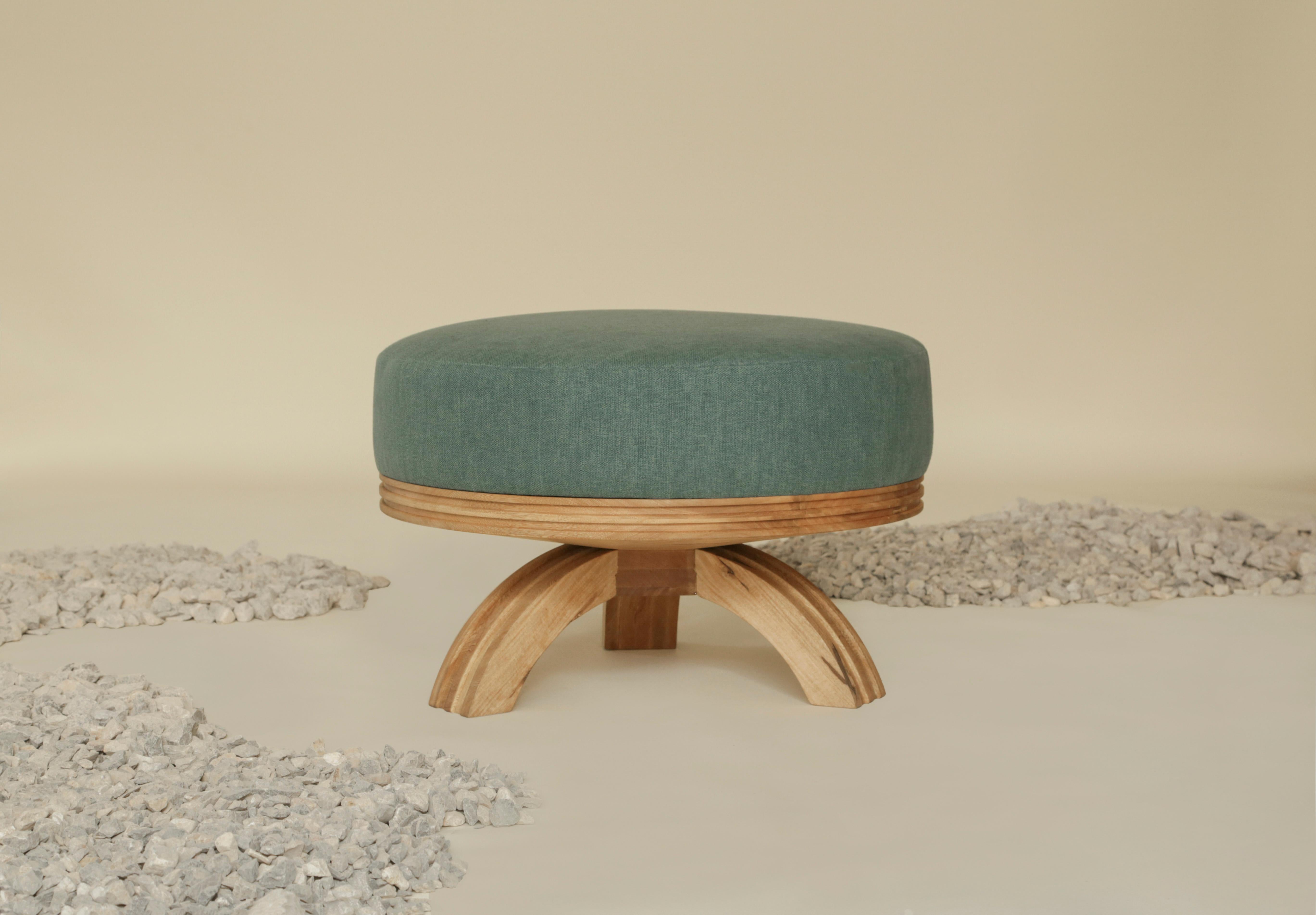 The Tara Ottoman is a unique piece that has a tripod base. It is made with Mexican rosa morada wood and the fabric can be personalized to fit your space. The piece is created by expert craftsmanship with great attention to detail. 