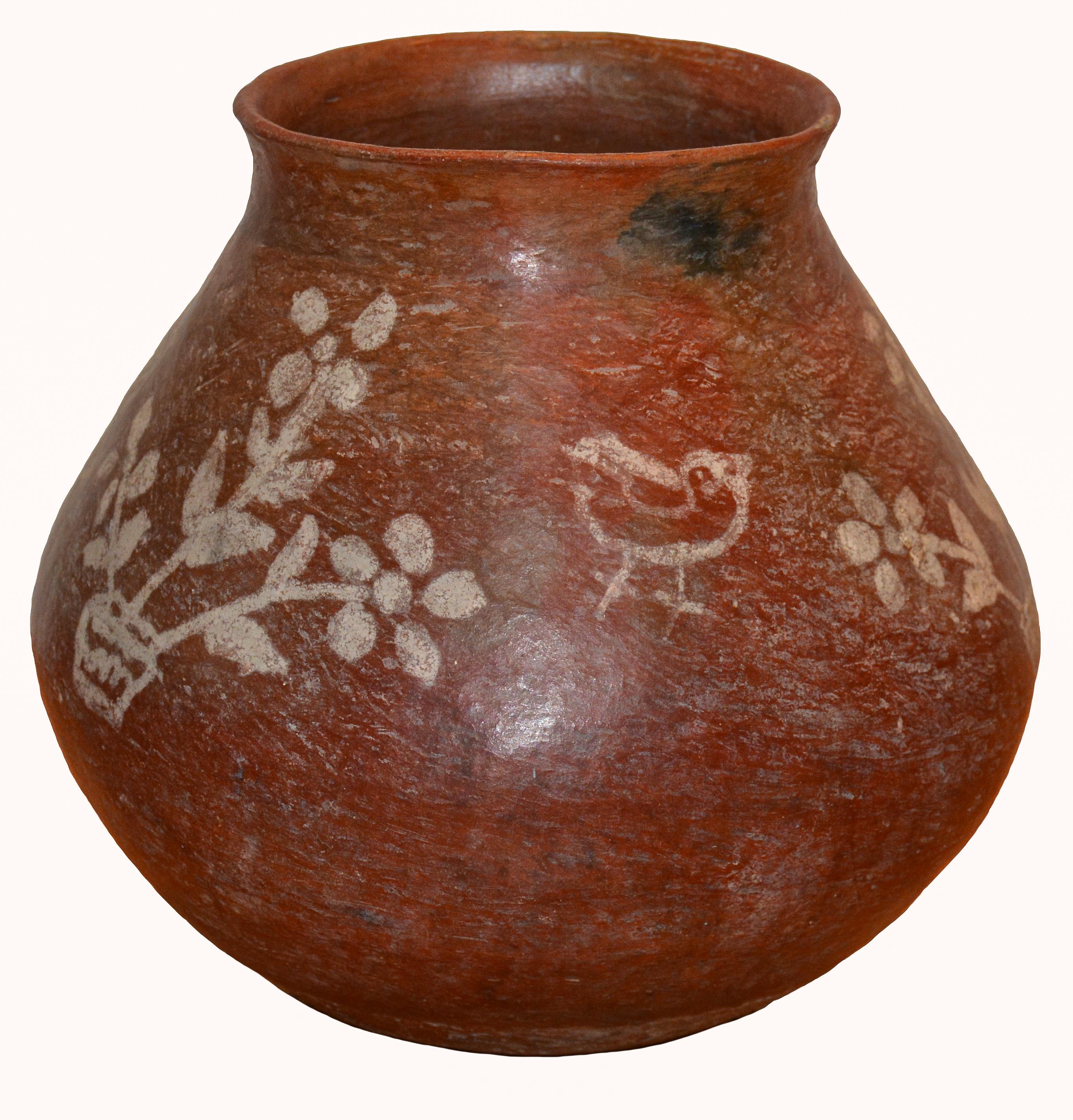Tarahumara Indian Red Clay Water Pot decorated with Birds and Floral Designs
Sierra Tarahumara Mountains, Chihuahua, Mexico
1940s
Low fire clay.
12 inches Height x 11 inches in Diameter

An unusual 1940s vintage red clay Tarahumara Indian