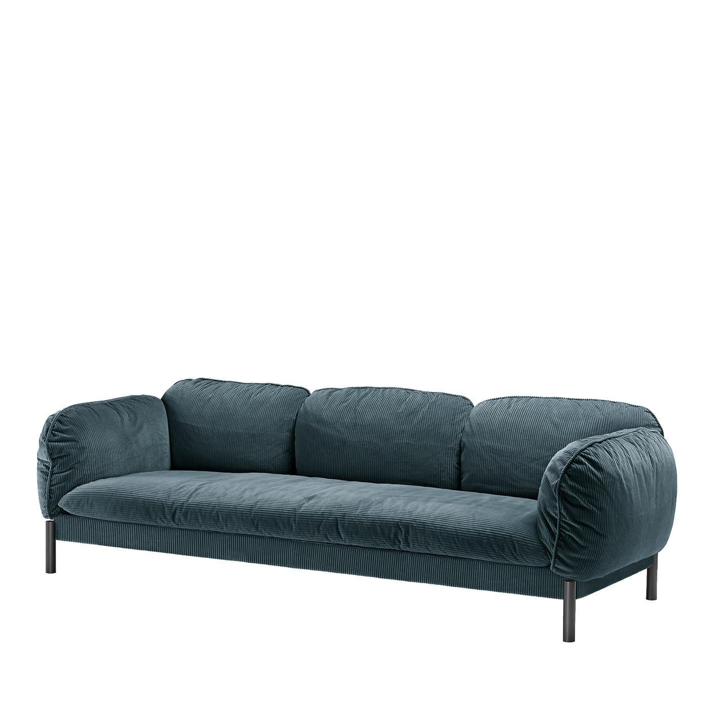 A trend echoing vintage references, corduroy was chosen by Lorenza Bozzoli as upholstery to dress this exquisite sofa, a piece that is an invitation to enjoy moments of pure comfort thanks to its fluffy, cushioned design and soft, blue velvet cover.