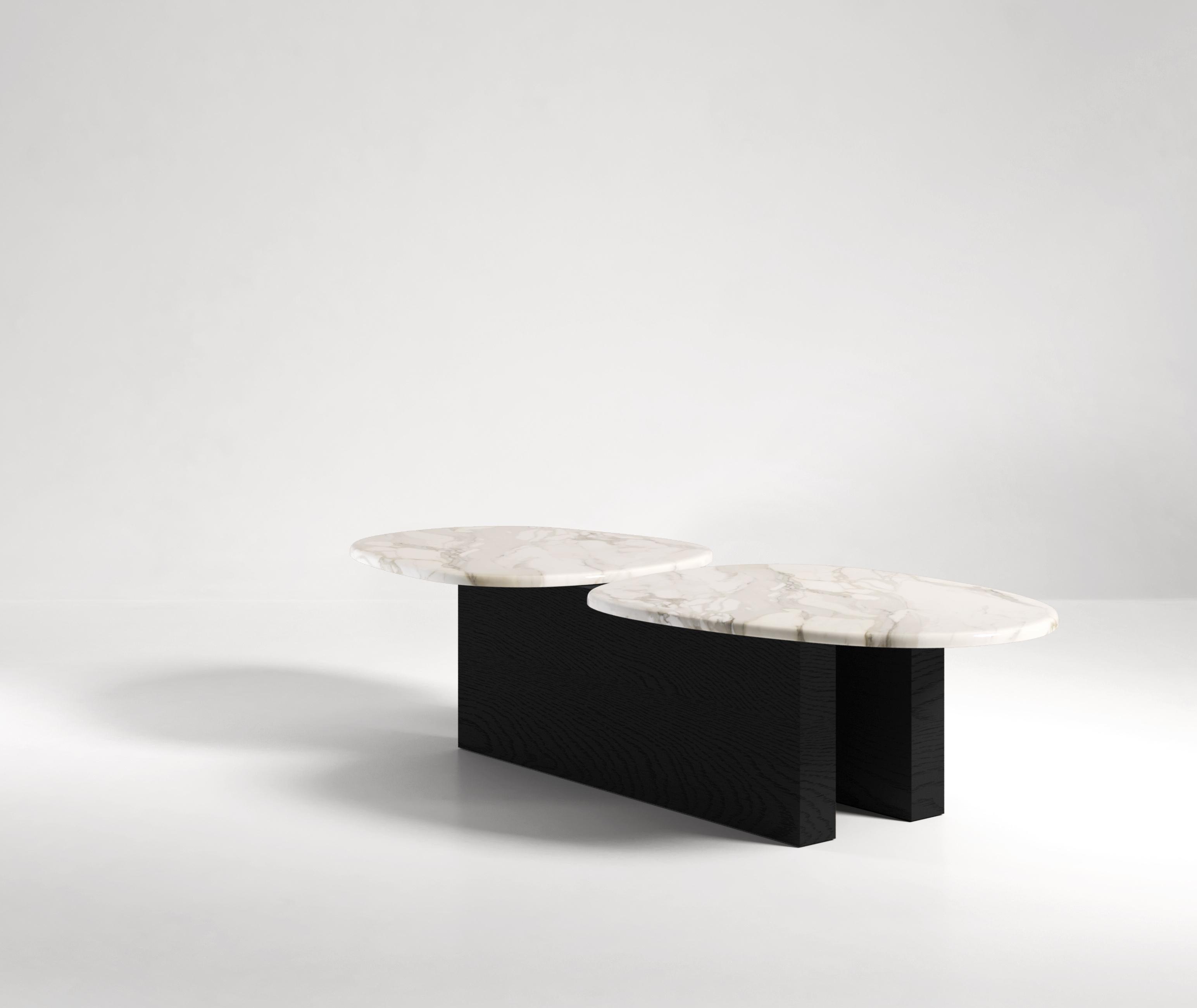 Named after the two seas of Taranto, the Taras coffee table consists of two marble or stone pieces held by another two solid wood slabs. The wooden pieces are joined only through the marble creating a unique and surprising balancing act. Available