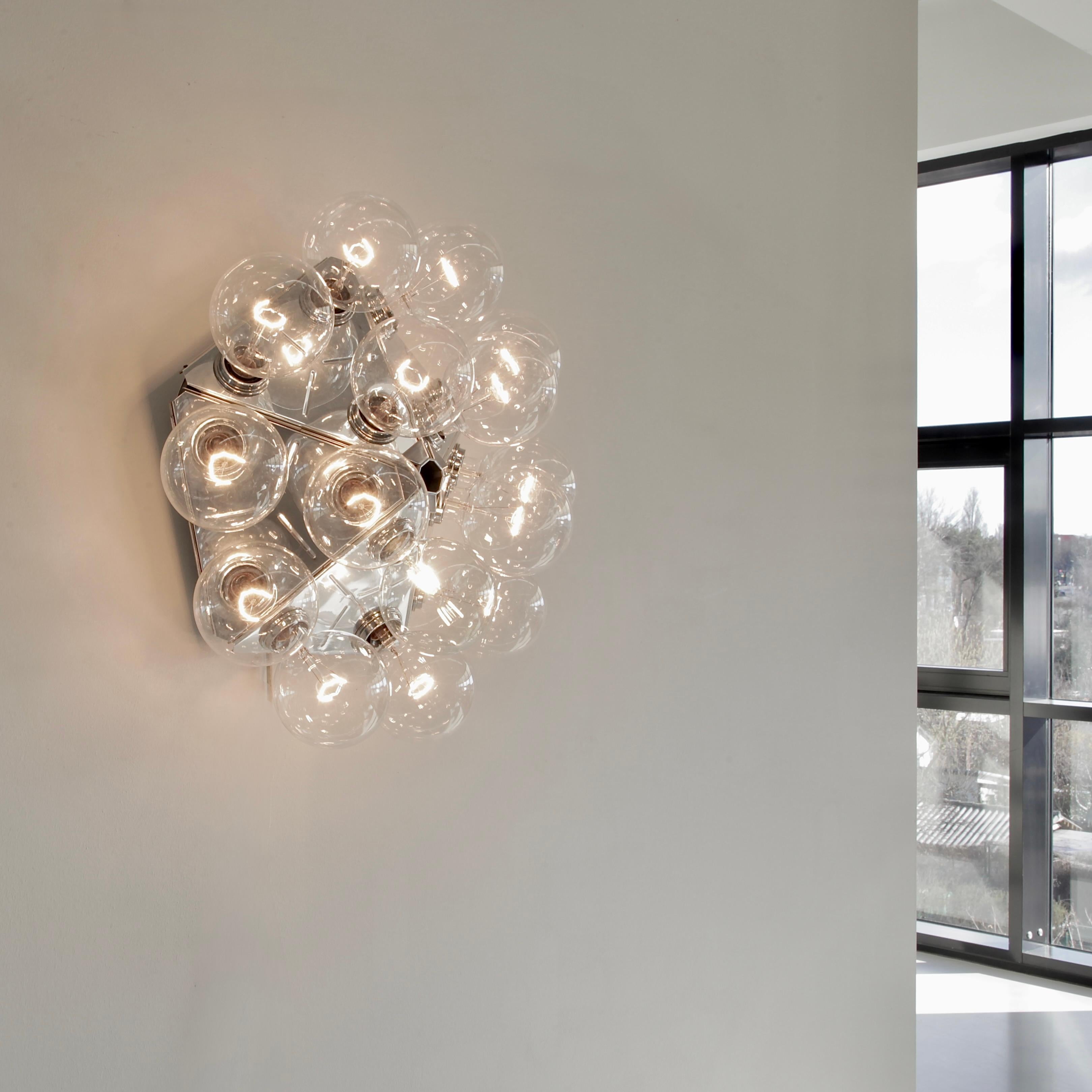 Wall lamp/ ceiling Lamp designed by Achille Castiglioni. Italy, FLOS, 1988.

Taraxacum 88 lamp is a octagon shaped chromed metal lamp with 15 LED glass globes designed in the late 1989's by Castiglioni. The name TARAXACUM comes from a flower species