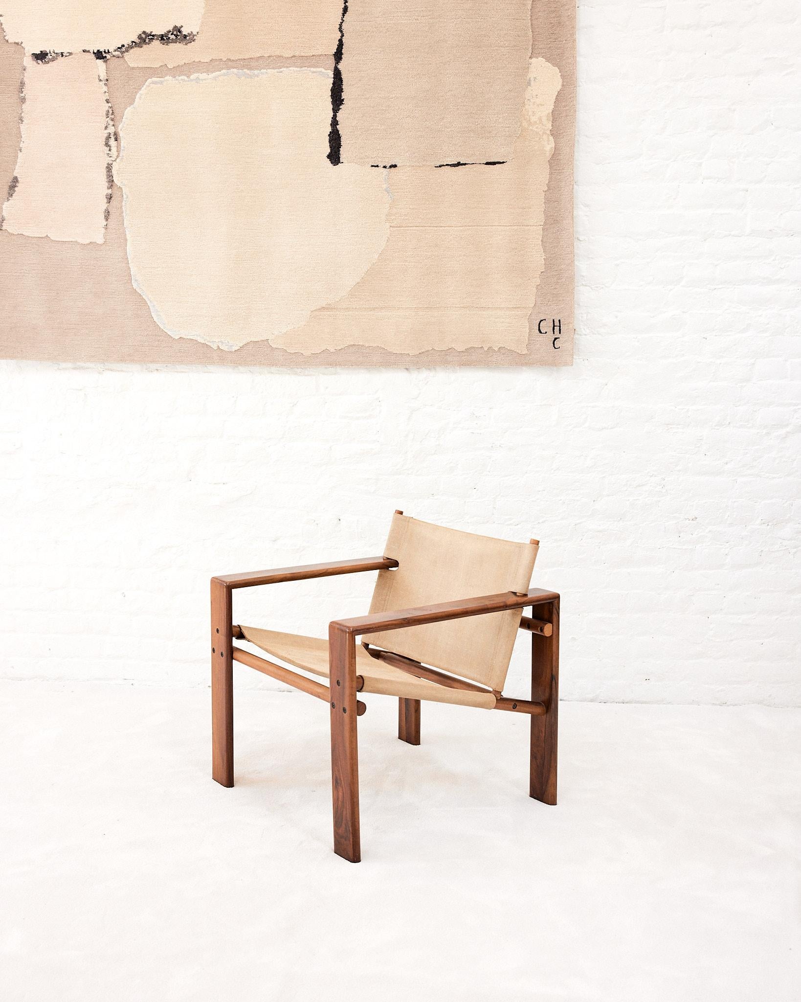 Italian 1970s armchair made with a wooden structure, raw hemp seat, and backseat, produced by Mobilgirgi for Cantu. The chair is made by the self taught craftsman and designer Tarcisio Colzani. His professional career began in the technical office