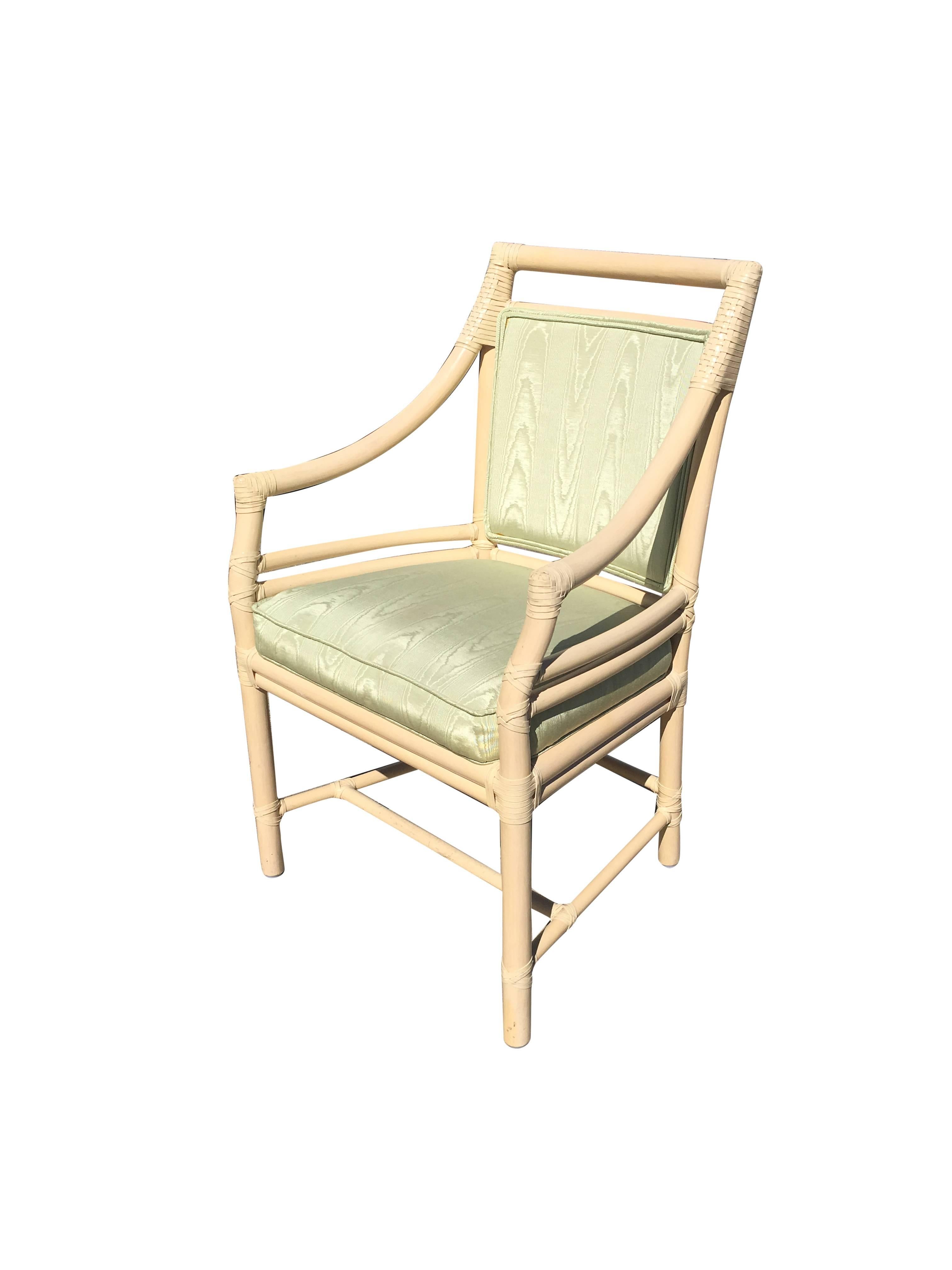 A great set of ten rattan dining chairs by McGuire. The set is as pictured. They are designed with the very popular target back style and have green sharkskin Fabric upholstered cushions.
 All chairs share the iconic McGuire leather strap wrappings.