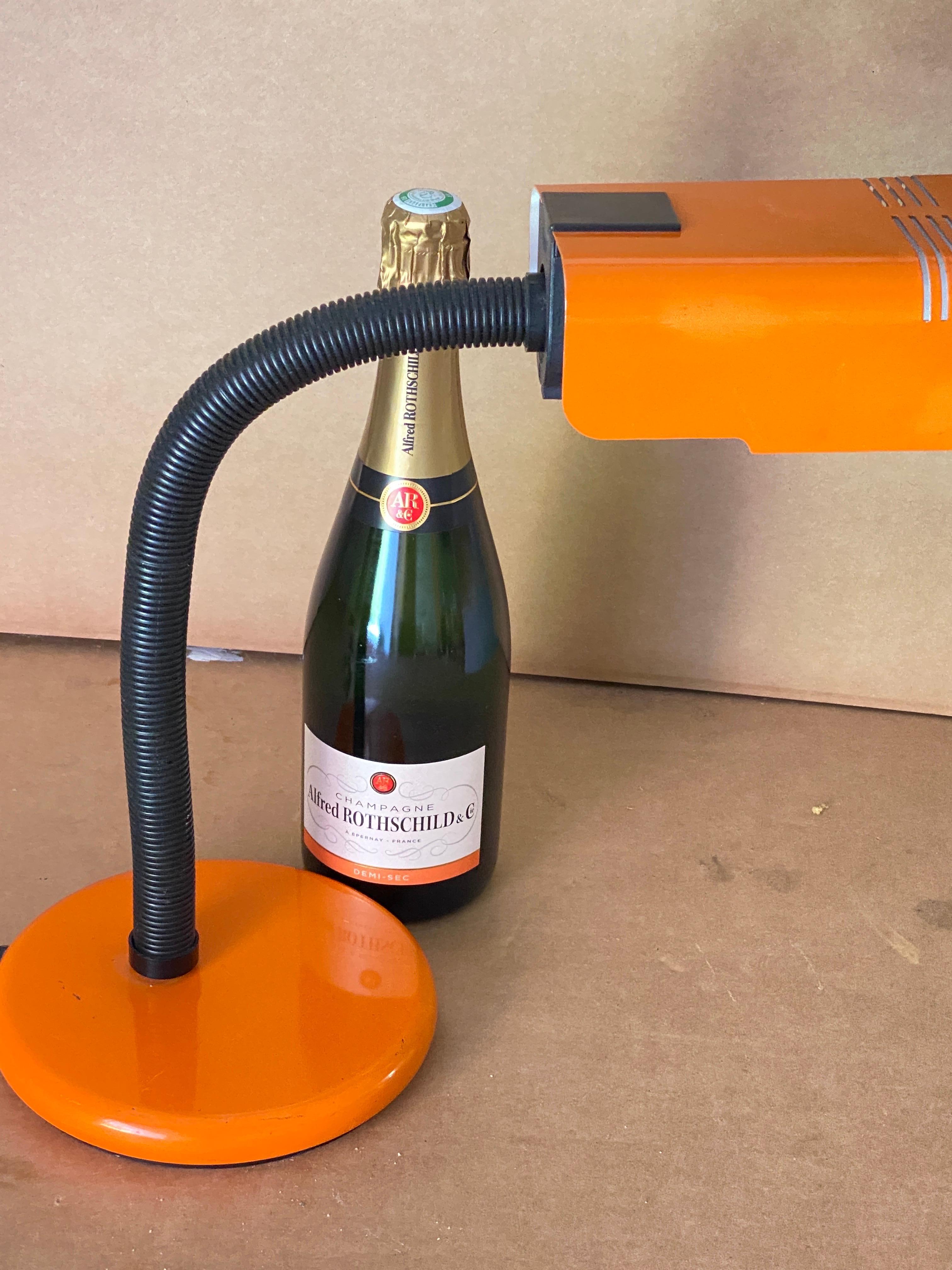 A Mid-Century Modern orange and black table lamp by Targetti. It works 110-240 volts and needs a regular e27 bulb. Lamp is marked on the bottom.
Articlable lamp, You can move either the assol lampshade or the shaft of the lamp by tilting down or up