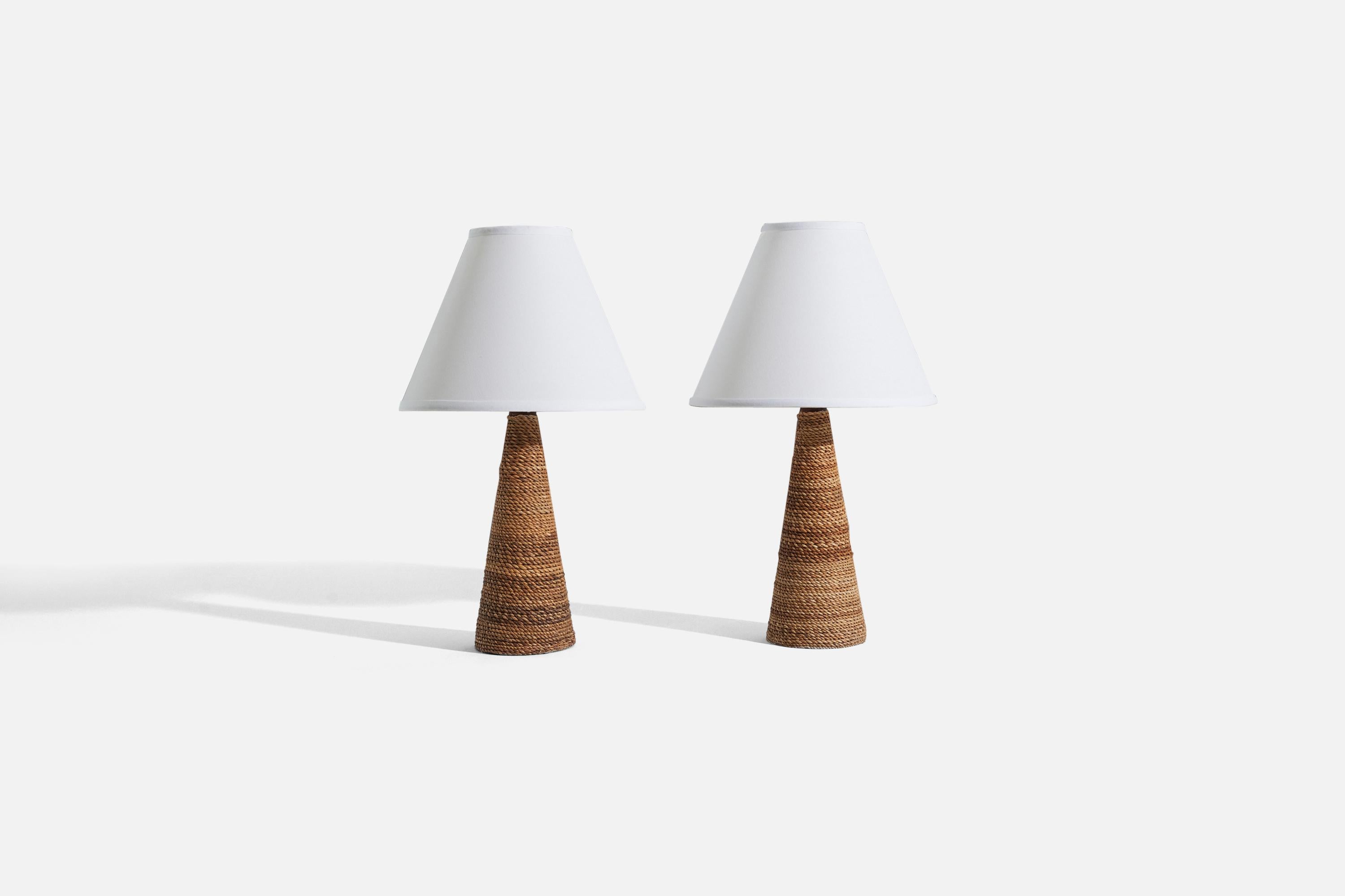 A pair of wood and waxed cord table lamps, designed and produced by Tarogo Japan, Philippines, c. 1980s-1990s.

Sold without lampshade. 
Dimensions of Lamp (inches) : 13.6875 x 4.125 x 4.125 (H x W x D)
Dimensions of Shade (inches) : 4 x 10 x 8 (T x