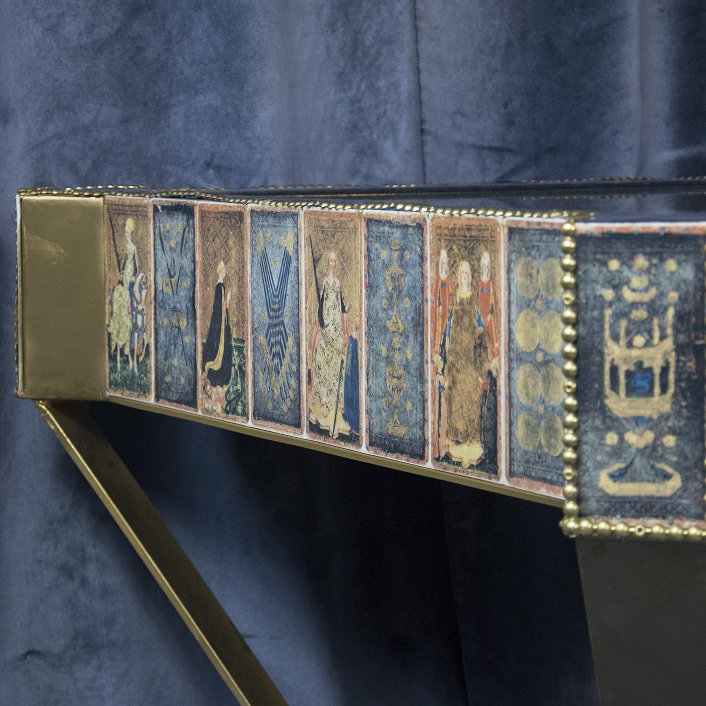 Conceived, designed, and brought to life by architect Paola Maria Russo, this superb table draws inspiration from the medieval tarot cards from Visconti di Modrone. The surface boasts a golden mirror and polished edge in blue velvet, while the sides