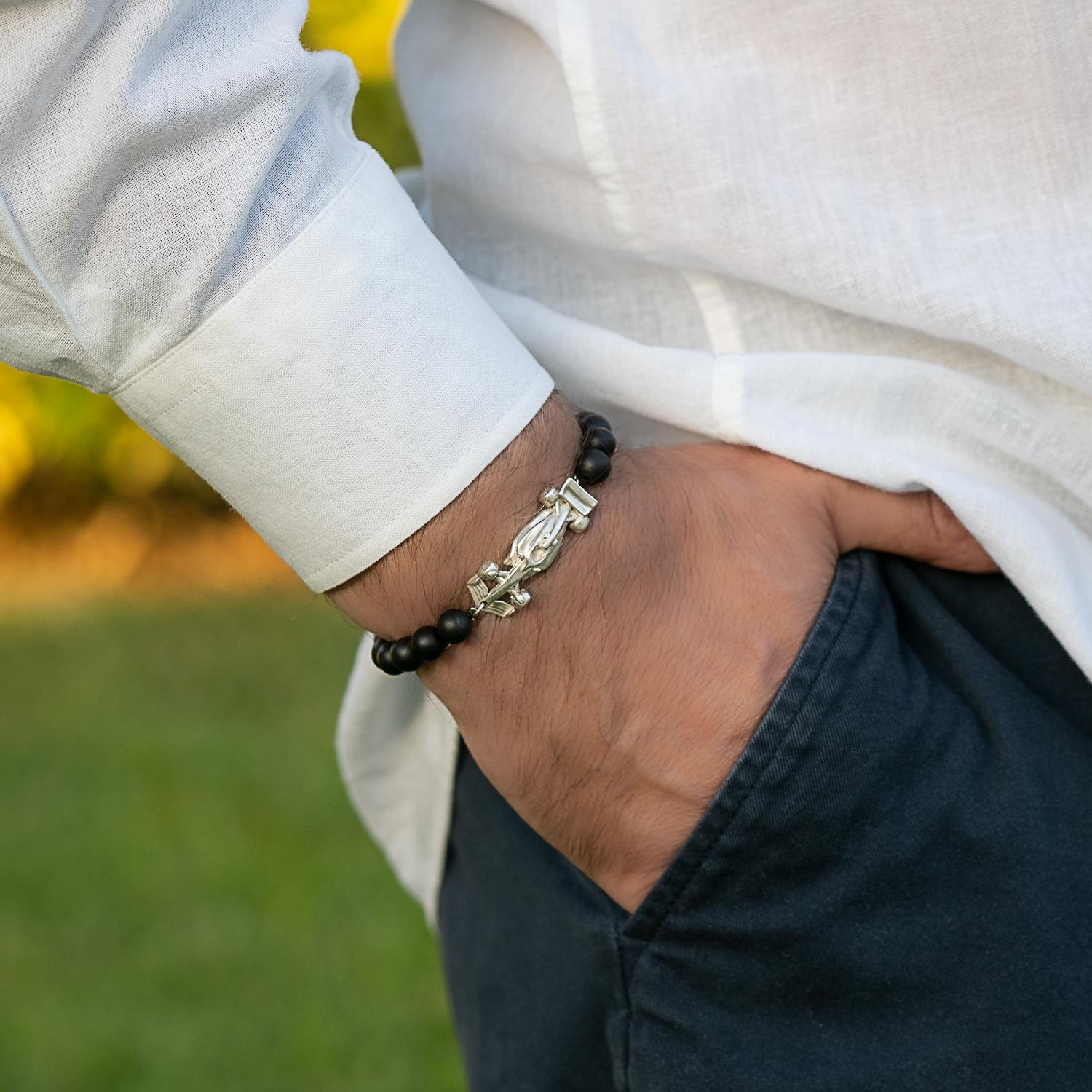 The Race Car Black Onyx Bracelet is a stunning piece that captures the essence of speed and adrenaline. Crafted from sterling silver, this bracelet features a sleek and aerodynamic race car design complete with intricate details. The streamlined