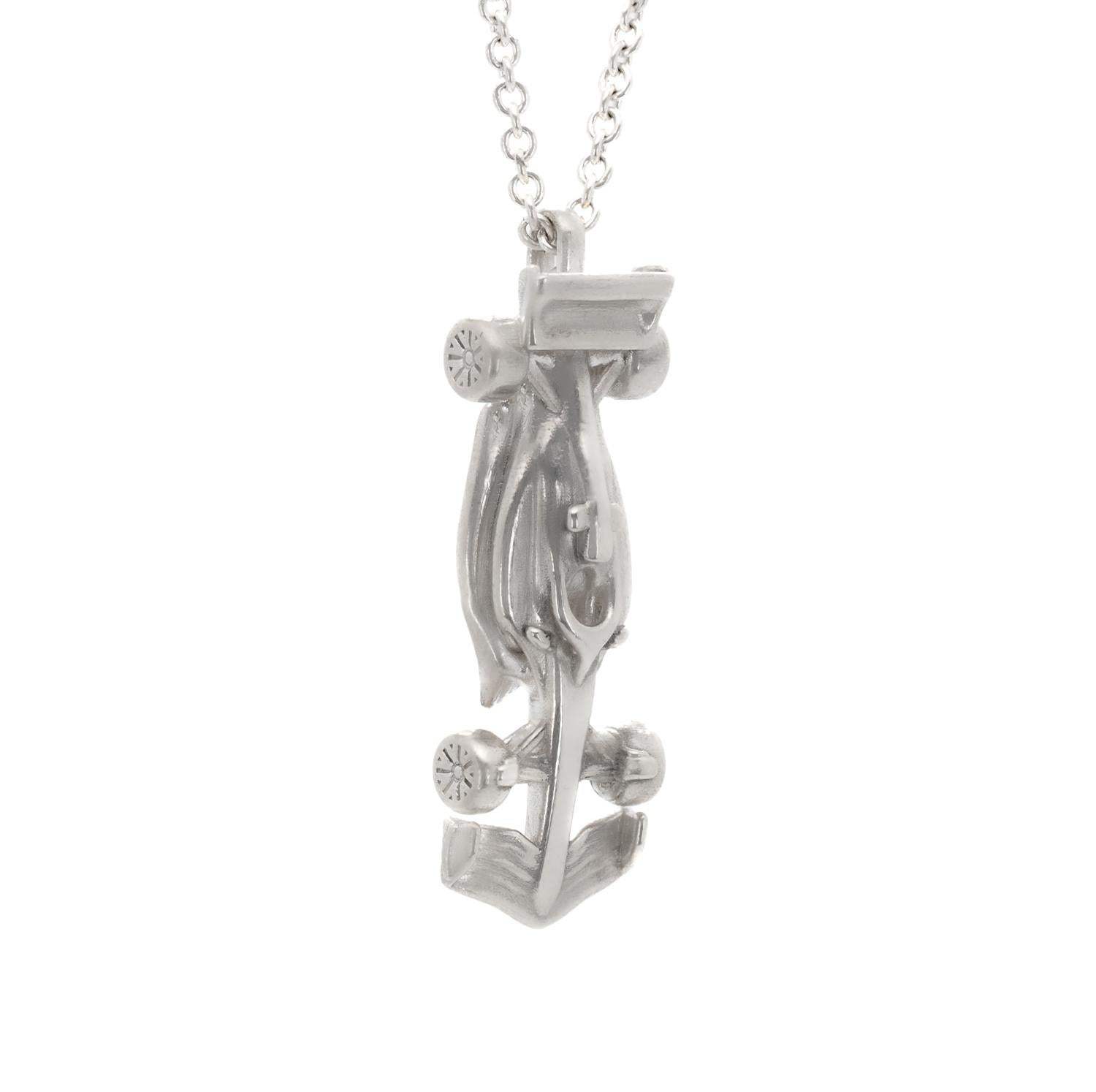 The Race Car Necklace is a stunning piece that captures the essence of speed and adrenaline. Crafted from sterling silver, this necklace features a sleek and aerodynamic race car design complete with intricate details. The streamlined body of the