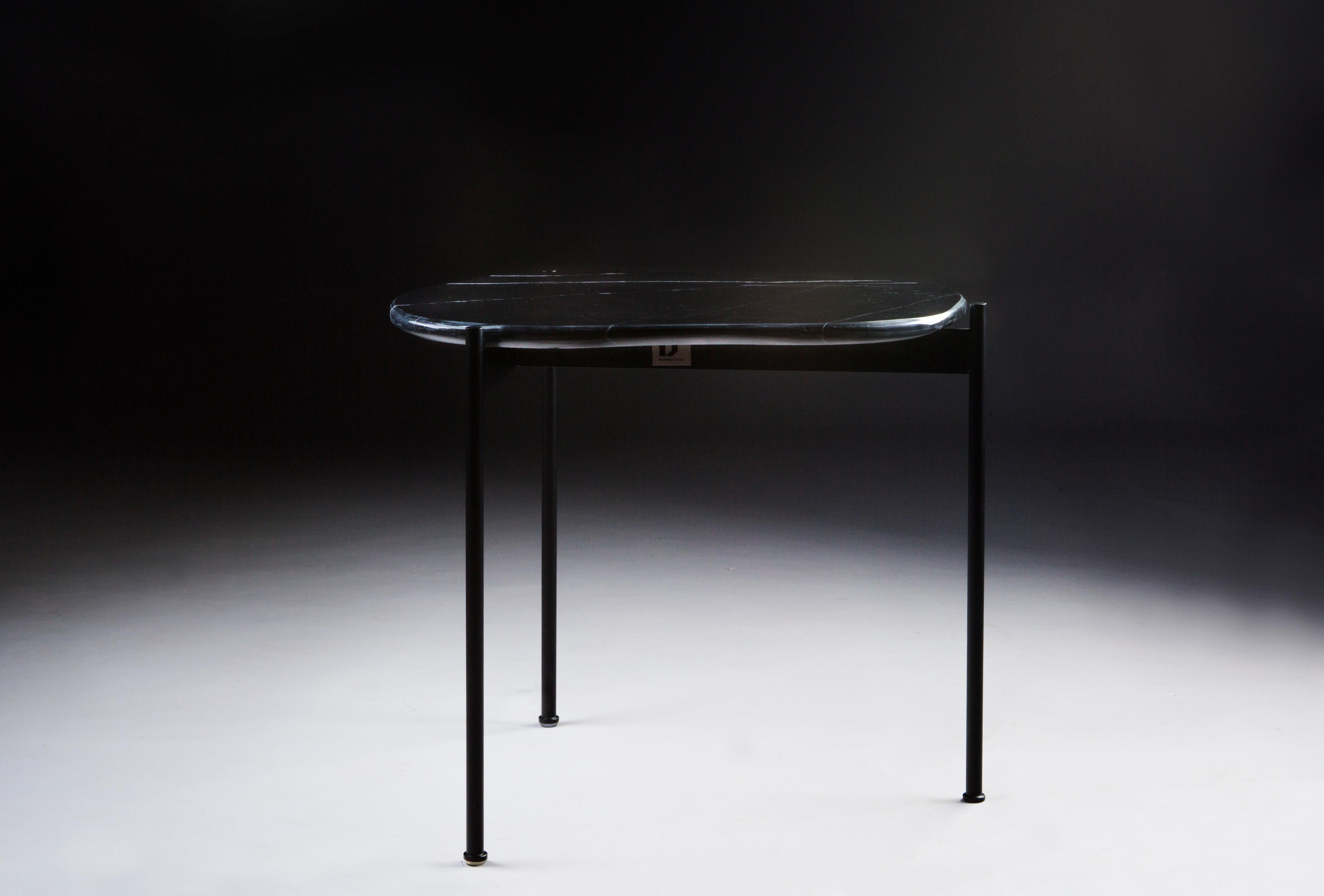 Tas coffee table by Rectangle Studio
Dimensions: W 44 x D 52 x H 45 cm 
Materials: Black marble, black paint coating on metal

We produced 'Tas02' which is inspired by the stones that are shaped by nature and with its free form.
On every