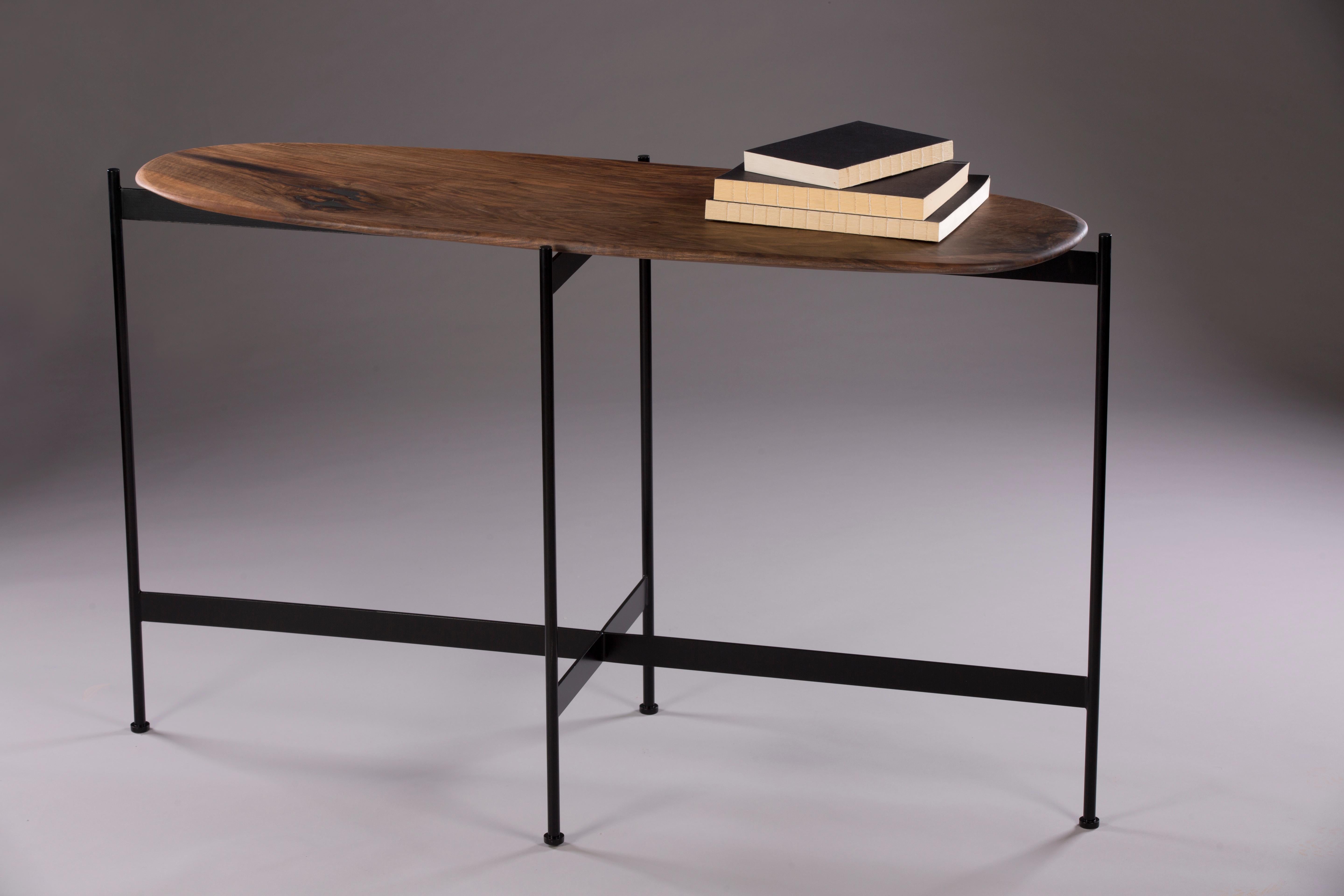 Tas console by Rectangle Studio
Dimensions: W 125 x D 45 x H 75 cm 
Materials: Massive walnut, natural wood oil, black paint coating on metal

The table is shaped and finished by the designer. For this reason, each table has different and