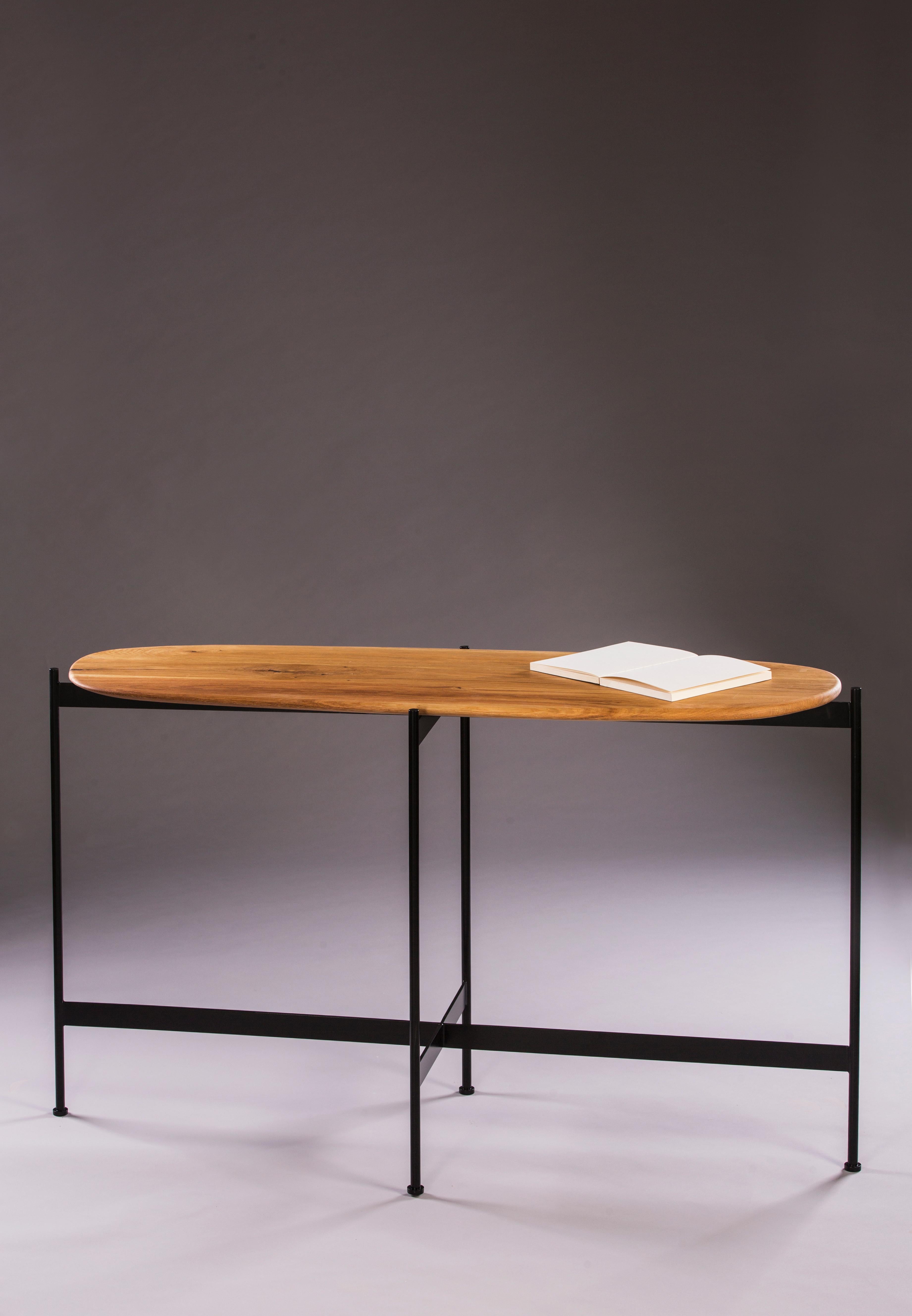 Tas console by Rectangle Studio
Dimensions: W 125 x D 45 x H 75 cm 
Materials: Massive oak, natural wood oil, black paint coating on metal

The table is shaped and finished by the designer. For this reason, each table has different and