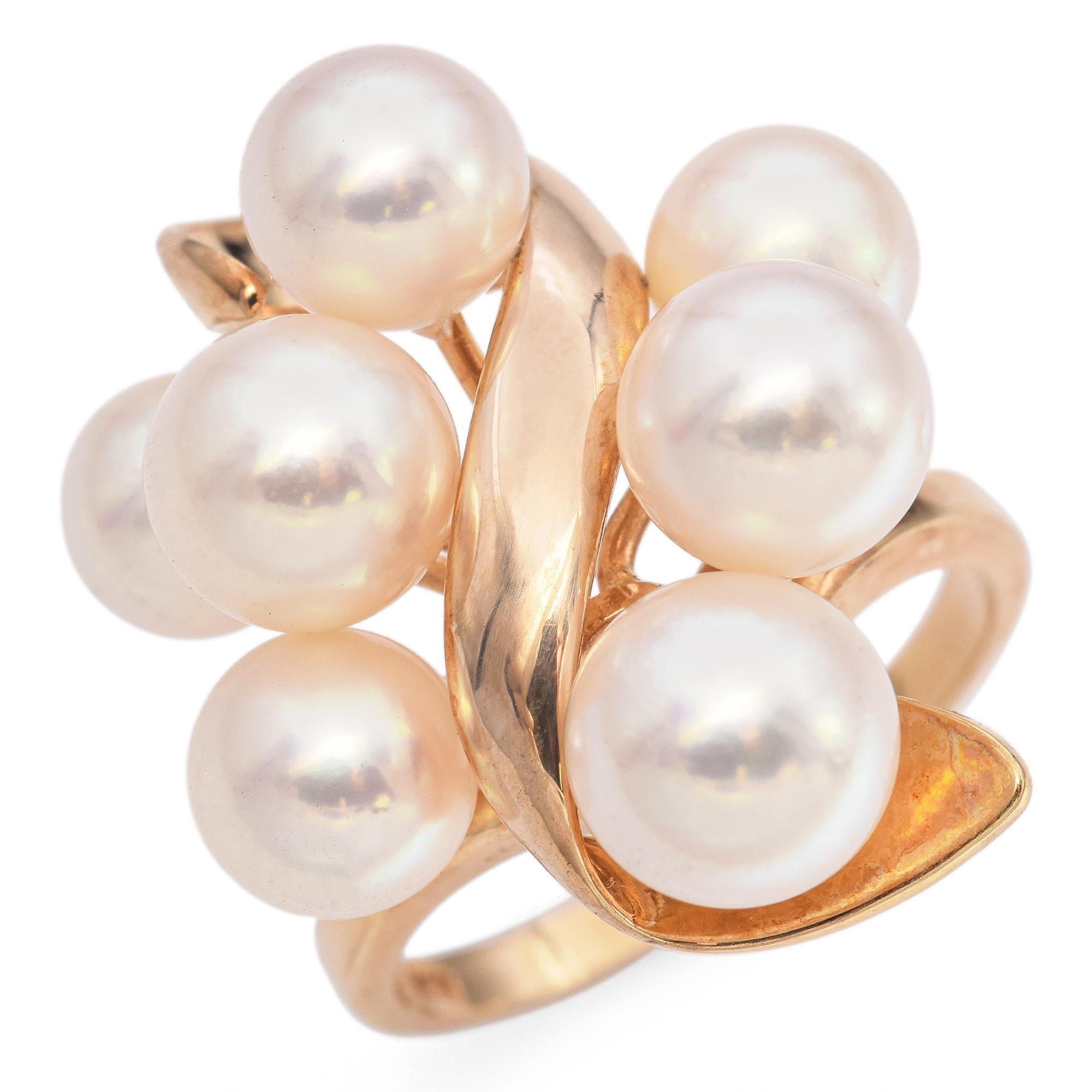 This striking ring by TASAKI showcases a cluster of lustrous white pearls, gracefully intertwined with polished 18k yellow gold. The pearls, with their soft glow, are artfully arranged to create a captivating visual flow, accentuating the ring's
