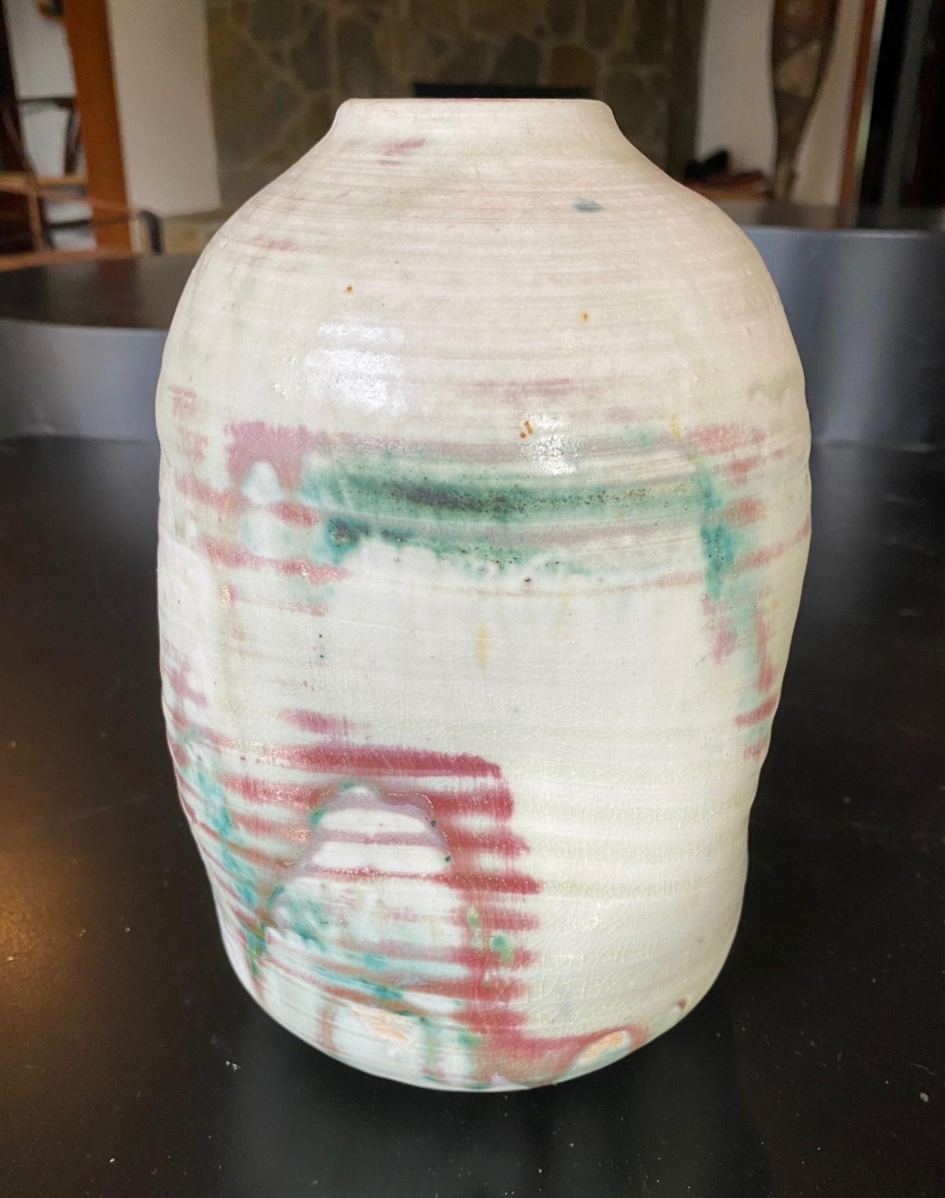 A beautiful, relatively large free form modernist abstract vase with indentations by famed Japanese Hawaiian American pottery master Toshiko Takaezu. The high-fired vase features a striking multi-colored minimalist drip glaze over a lightly glazed