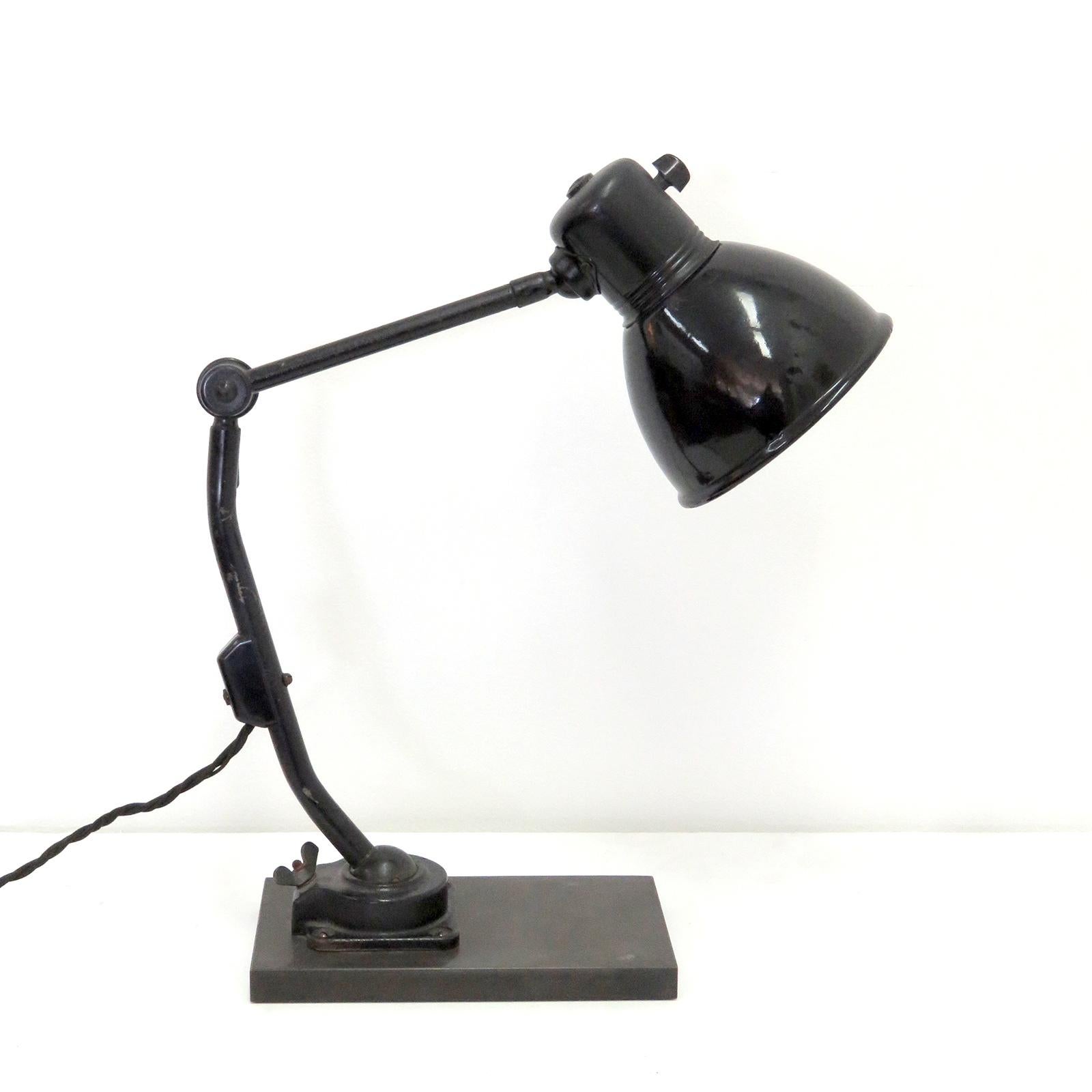 Striking 1930s task lamp No.802PL by Marianne Brandt for Kandem (1934-1939), enameled black with a white shade interior, with custom solid steel bases, can be used as wall or table lamp, ball joints at the original base and head, as well as a