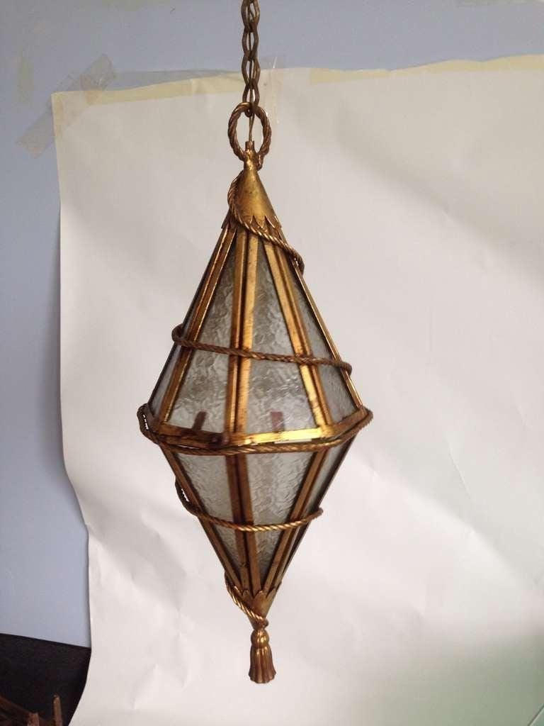 Gilded iron and frosted glass with tassel trim, this Venetian style Italian hanging light.