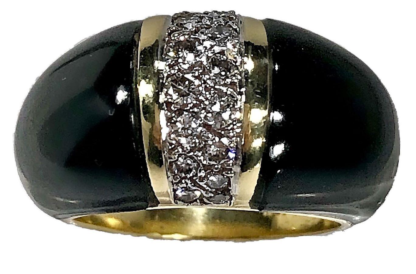 This lovely onyx and diamond ring is crisp and tailored, ideal for every day wear. It was made in the 1970's of 18k yellow gold with a generous strip of brilliant cut diamonds having  a total weight of .50ct at it's center and with black onyx