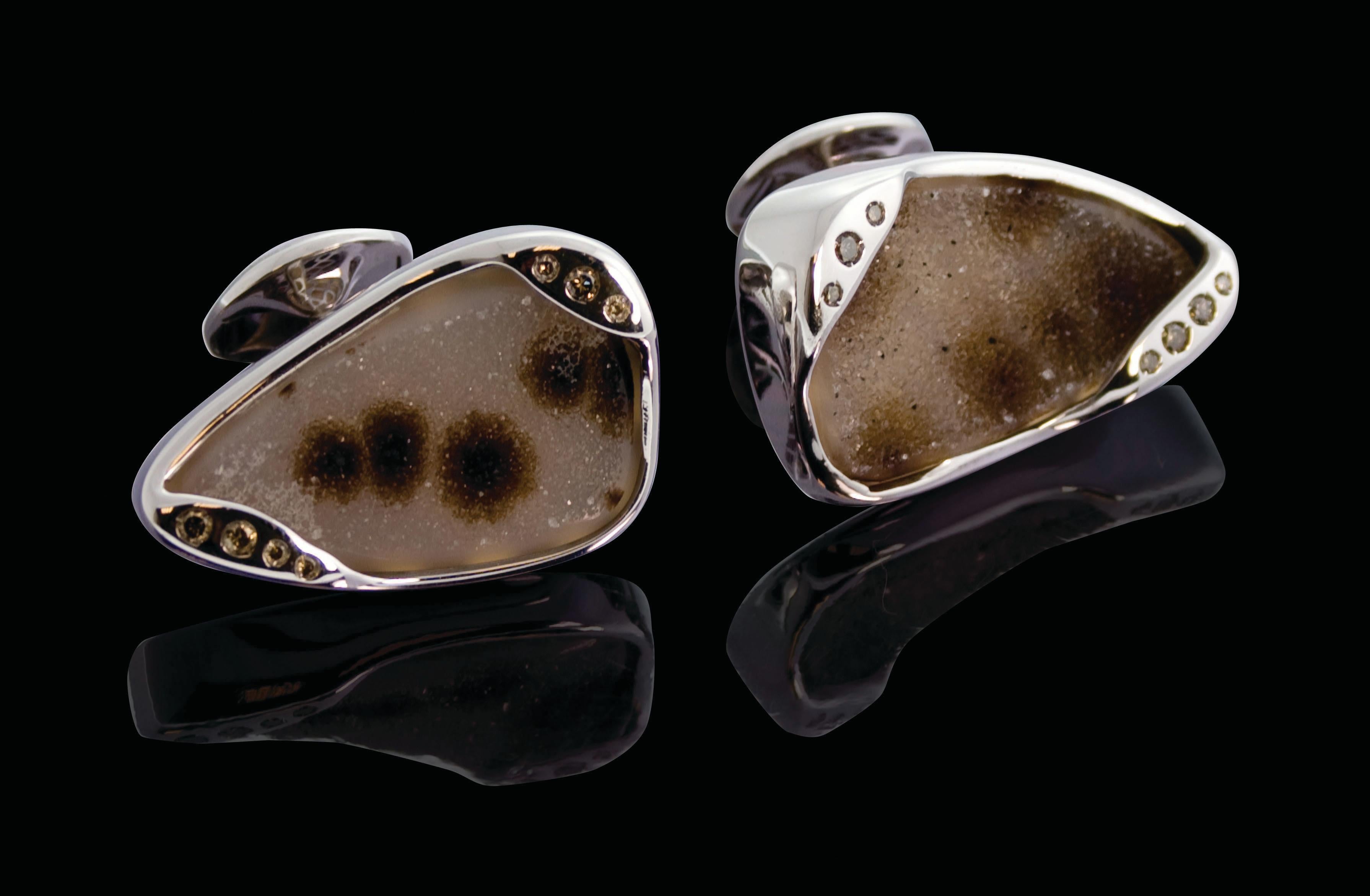 An extraordinary pair of cufflinks of unusual and eye catching stone, all with an organic bezel setting, dotted with subtle diamonds. A magnificent accessory with unique characteristics.
