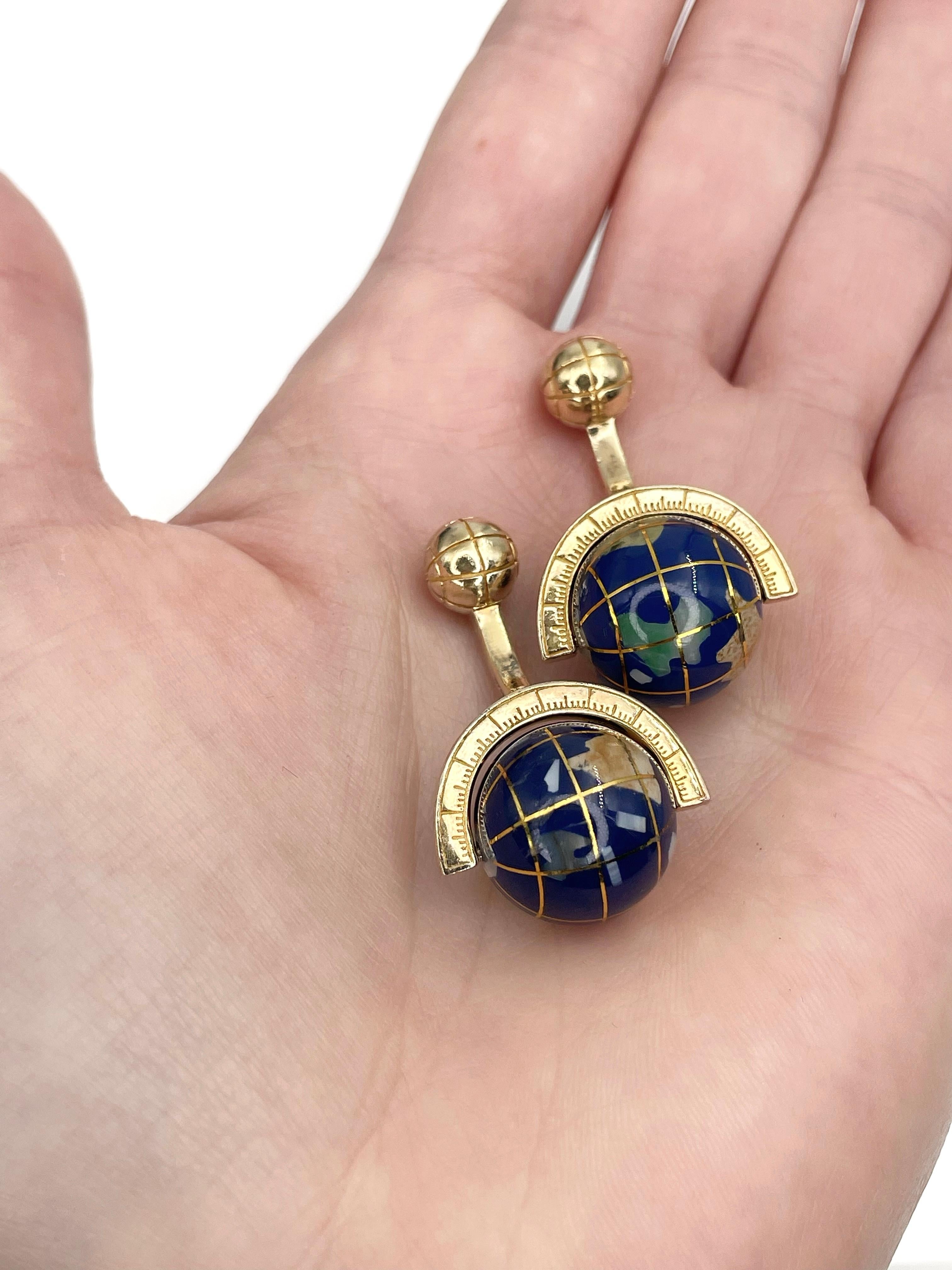 This is a playful pair of globe cufflinks designed by Tateossian in 2000’s. The piece is crafted in 925 silver and is gold plated. Spinning world spheres are made up of complex mosaic with blue lapis lazuli inlayed with semi-precious stone.

This