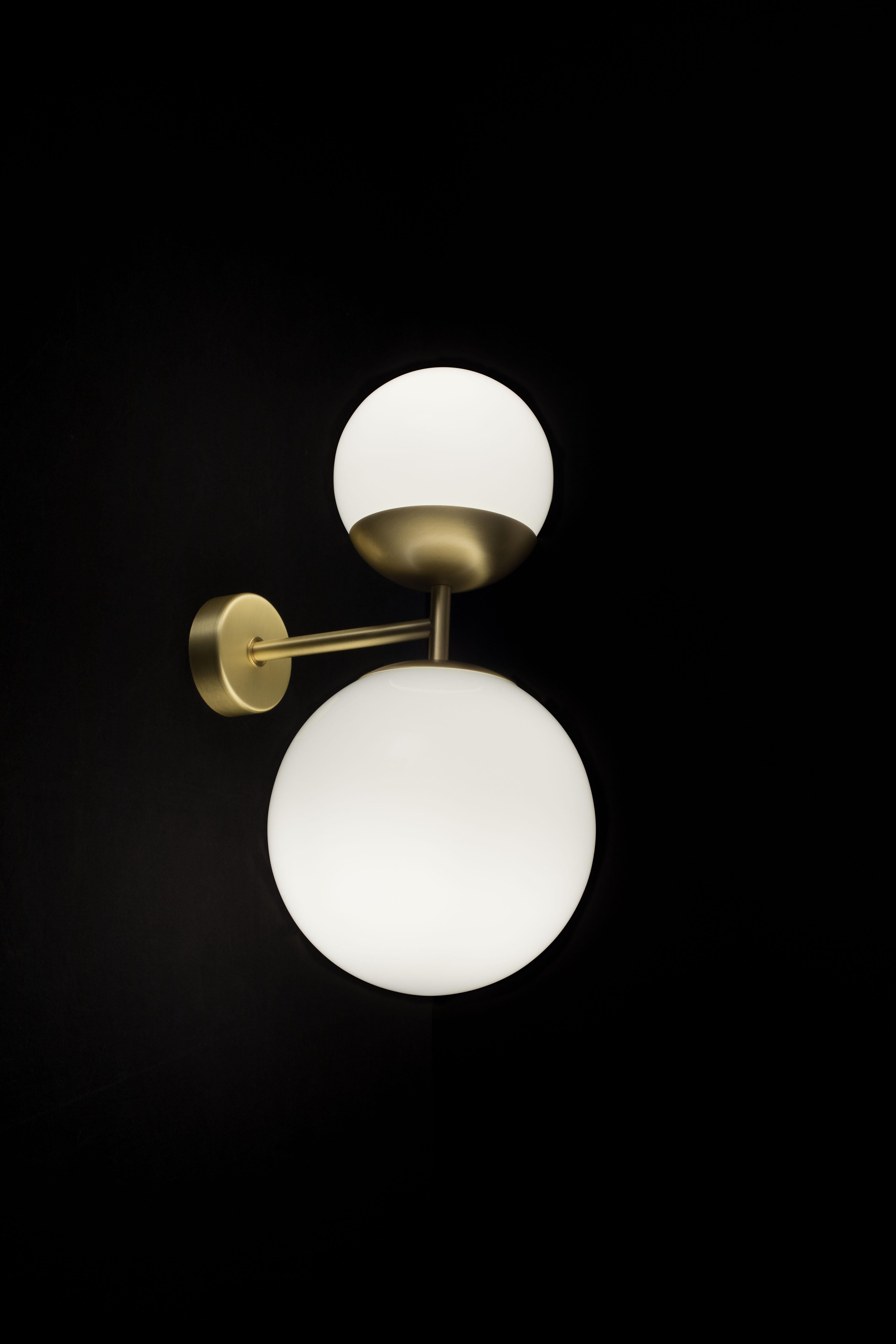 Biba Applique wall lamp in satin brass and white glass for Tato Italia. 

Designed by Lorenza Bozzoli in 2017 this lamp is executed in a brushed brass combined with white glass using the finest materials available and to the exacting standards of