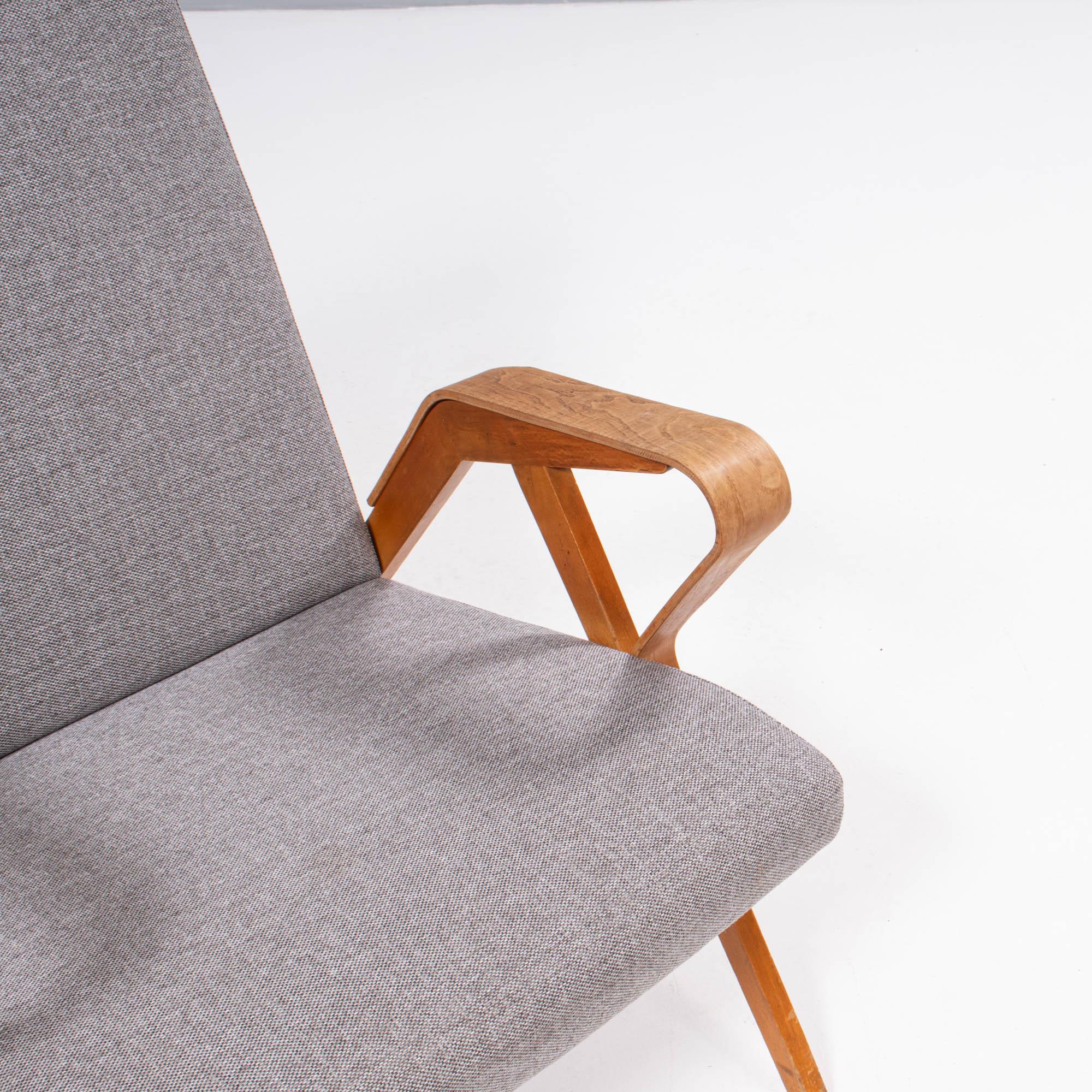 Designed by František Jirák for Tatra Nábytok, this No.24-23 chair is a fantastic example of mid century modern design.

Featuring bent plywood armrests which contrast the angular beech veneer frame, the armchair is upholstered in grey