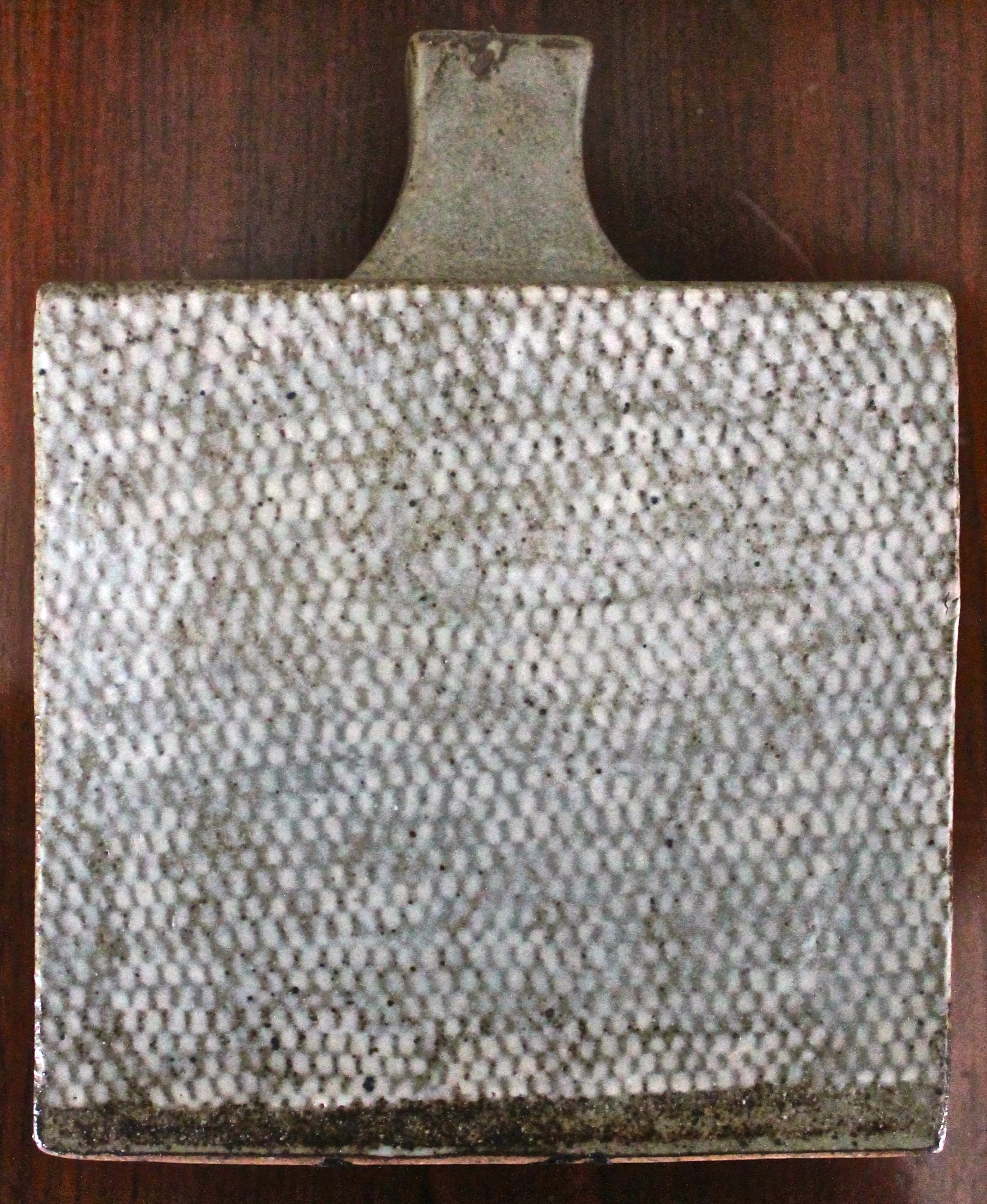 Beautiful flask in the tradition of Hamada, but with the original embossed textured fish net innovation of his protoge Tatsuzo Shimaoka (1996 Japanese National Living Treasure).