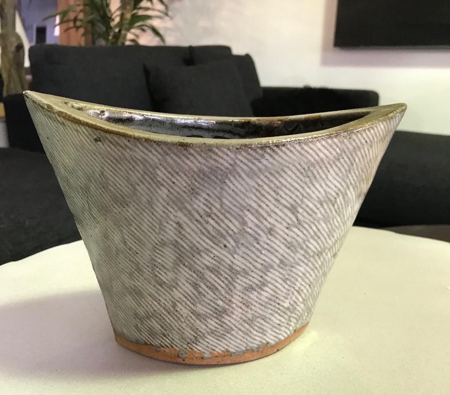 A rare and unique ceramic vessel by Japanese National Treasure pottery artist Tatsuzo Shimaoka. This work exhibits his signature rope inlay, cord pattern decoration technique. Comes with original artist signed and stamped wooden protective box.