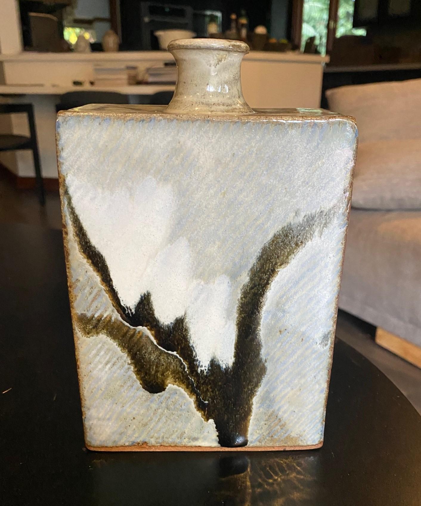 A wonderfully designed and gorgeously glazed coveted square Mingei bottle vase by Japanese National Treasure pottery master Tatsuzo Shimaoka.  The rich, sumptuous hand painted glaze radiates in the light.

The vase is signed by Shimaoka with his