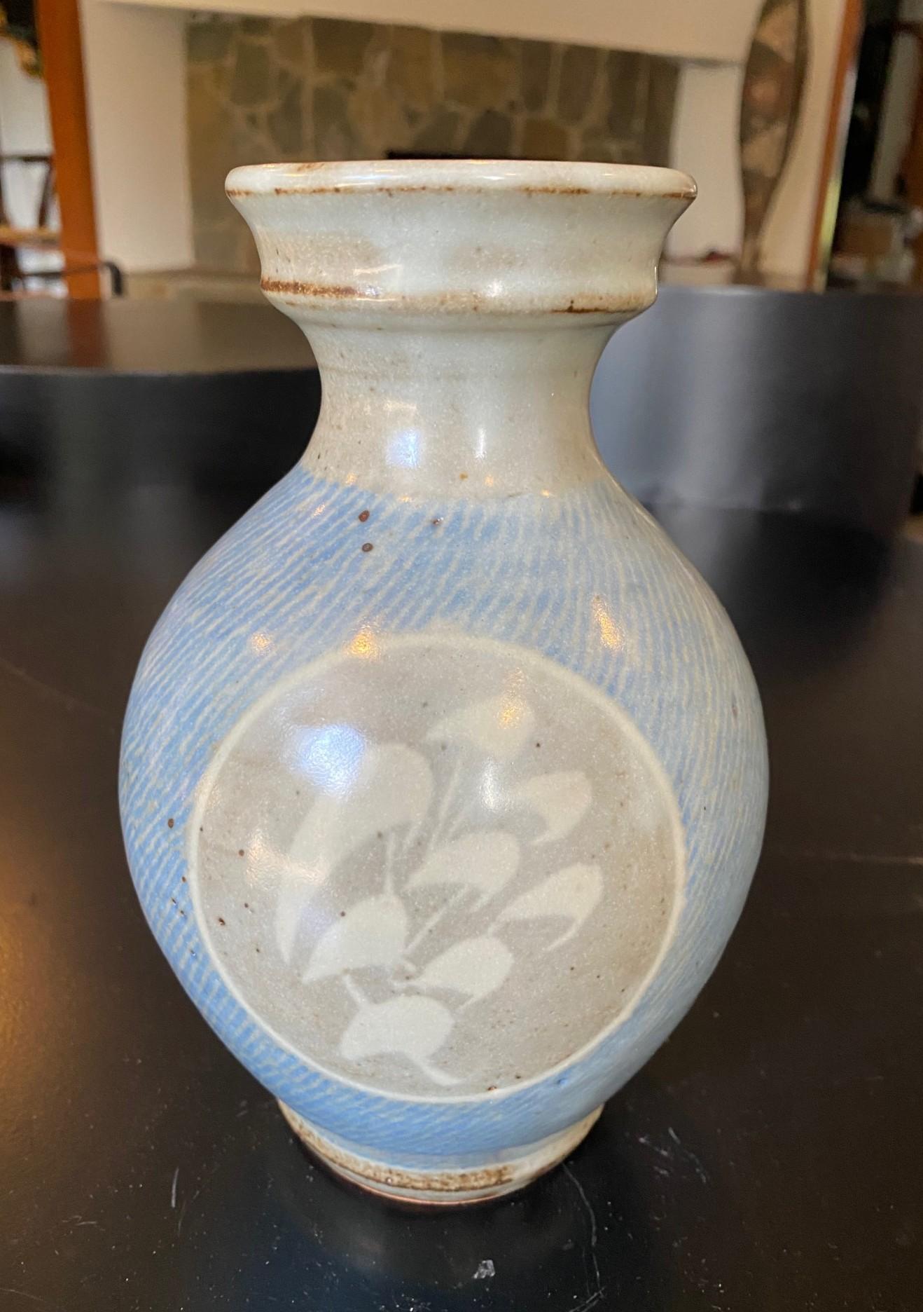 A wonderfully designed and gorgeously glazed Mashiko Ware curved Mingei vase by Japanese National Treasure pottery master Tatsuzo Shimaoka.  This work displays his famous Jomon Zogan rope inlay pattern design and hand-painted decoration with