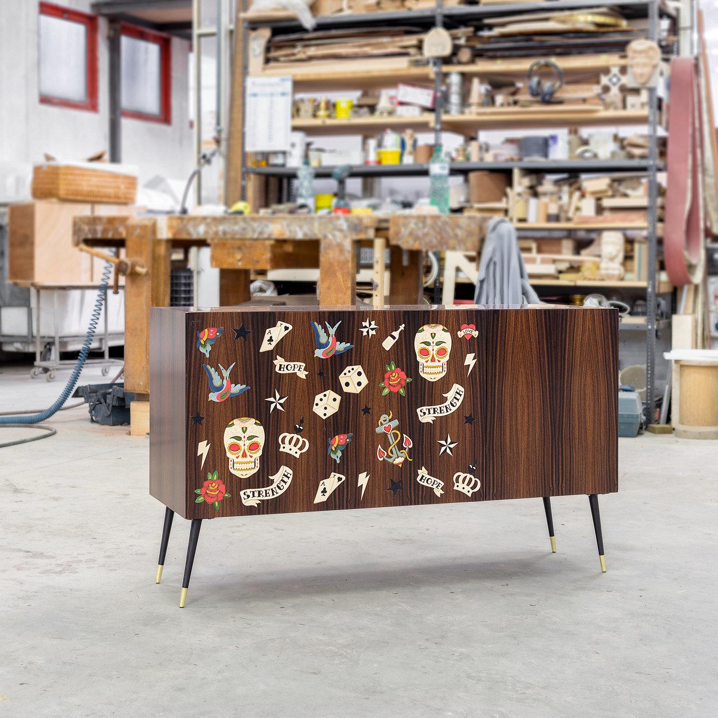 Entièrement fabriqué à la main en palissandre de Rio, ce meuble de bar présente un motif d'incrustation fantaisiste de tatouages populaires créés à l'aide de diverses essences de bois. Cette pièce est à la fois décorative et fonctionnelle : une