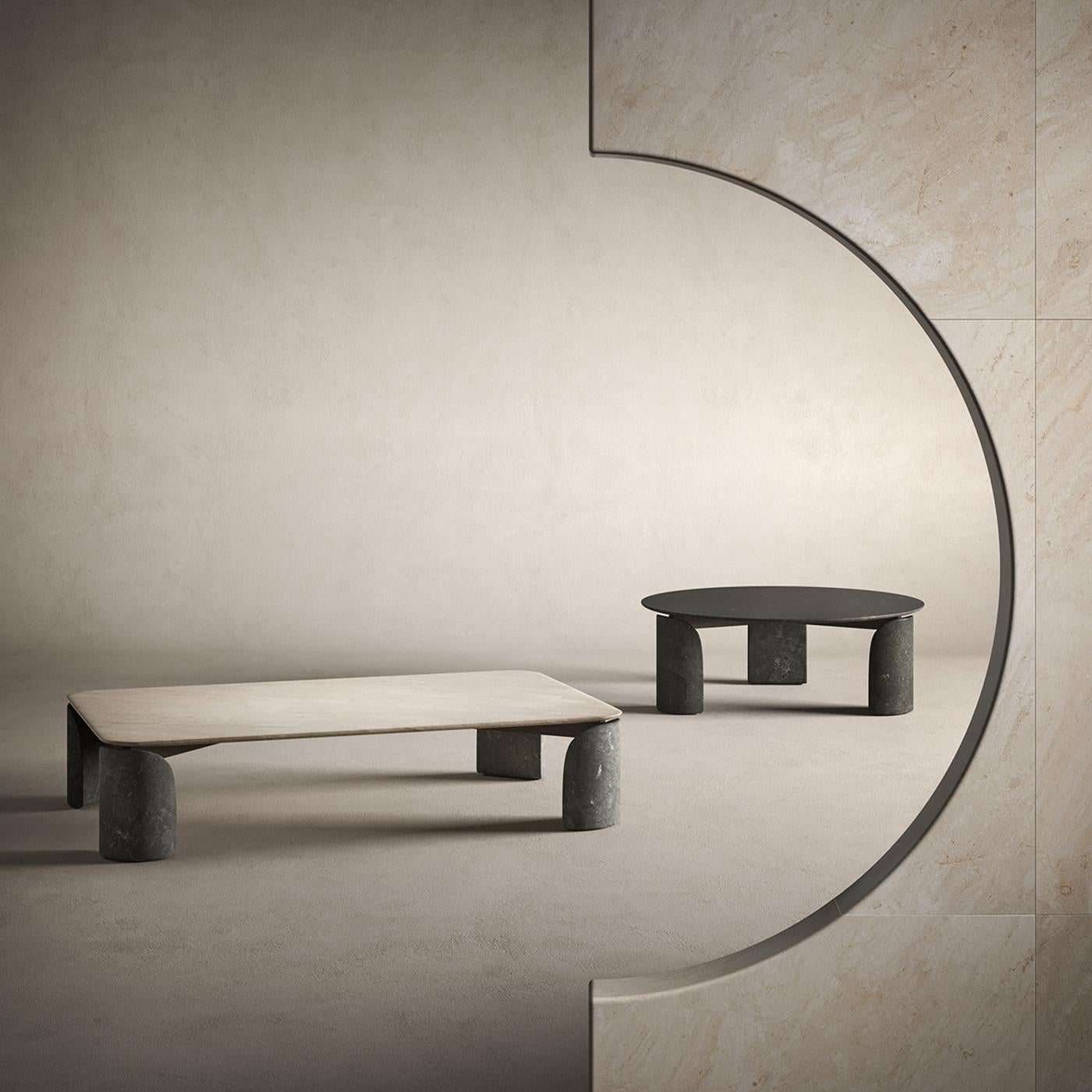 Rounded edges and curved profiles soften the general rigor of this coffee table, crafted using precious Avola stone for the curved legs and beige-toned Crema d'Orcia for the top. Its generous dimensions allows one to comfortably enjoy an afternoon