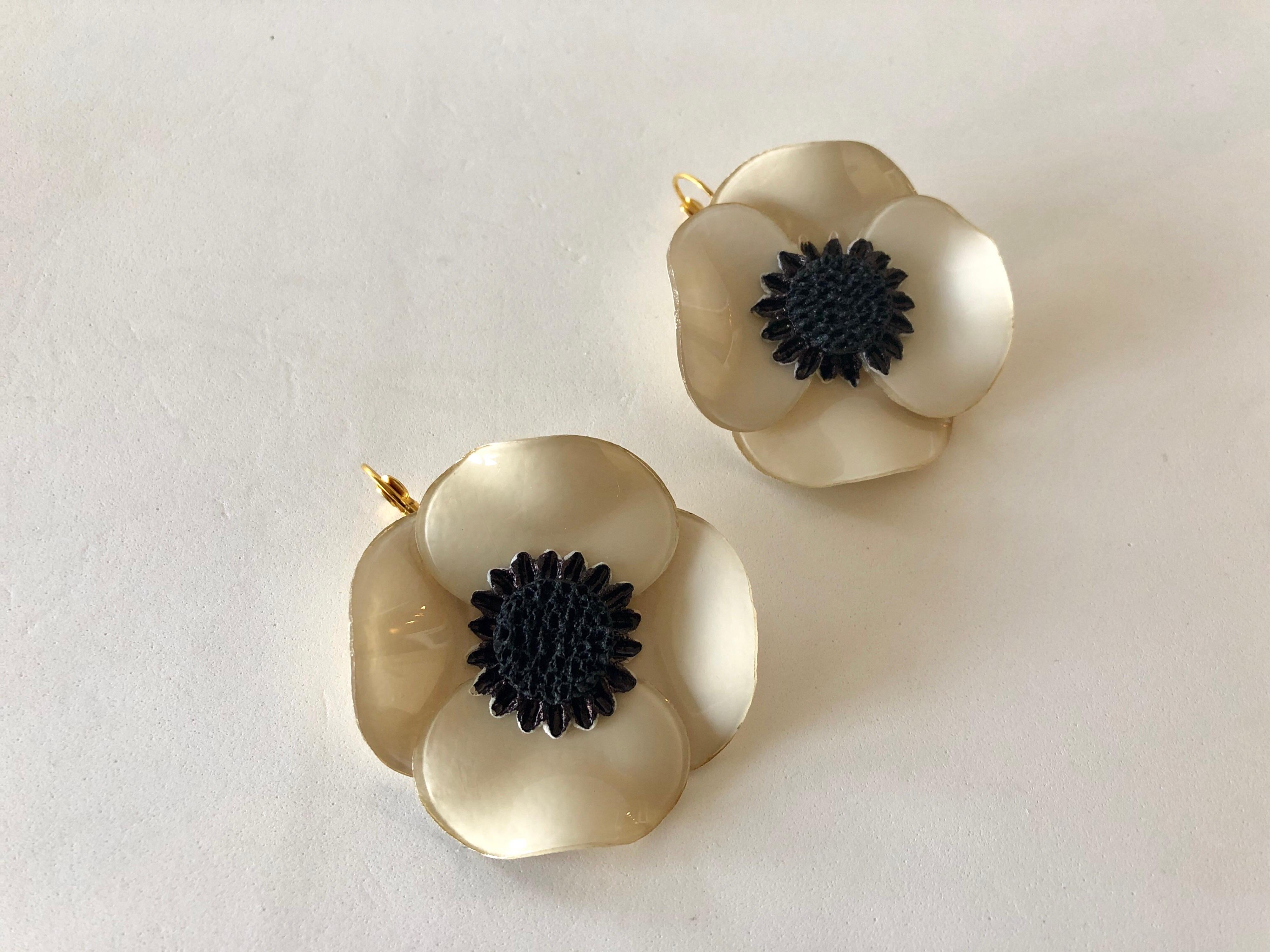 Light and easy to wear, these handmade artisanal pierced were made in Paris by Cilea. The lightweight earrings feature a single architectural enameline (enamel and resin composite) taupe poppy flower. The poppies are oversized and feature a black