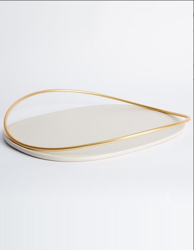 Taupe Touché D tray by Mason Editions
Dimensions: 36 × 48 × 6.4 cm
Materials: Iron and MDF
Colors: taupe, cotto, burgundy, sage green, petrol green

A light metal rod that rests on the surface and then lifts up, almost touching the surface with a