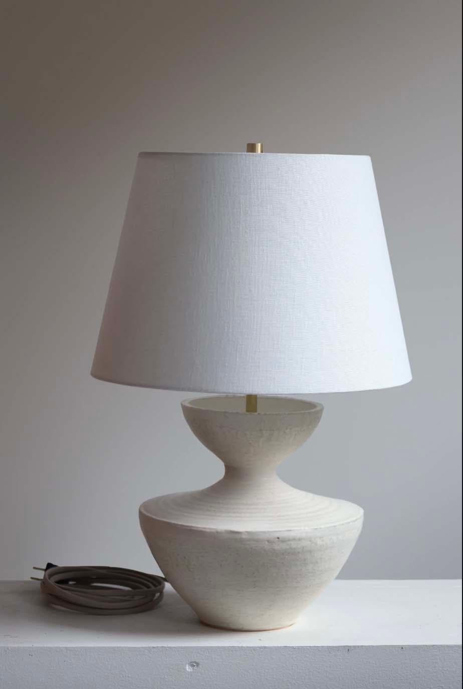 The Tauria lamp is handmade studio pottery by ceramic artist by Danny Kaplan. Shade included. Please note exact dimensions may vary.

Born in New York City and raised in Aix-en-Provence, France, Danny Kaplan’s passion for ceramics was shaped by